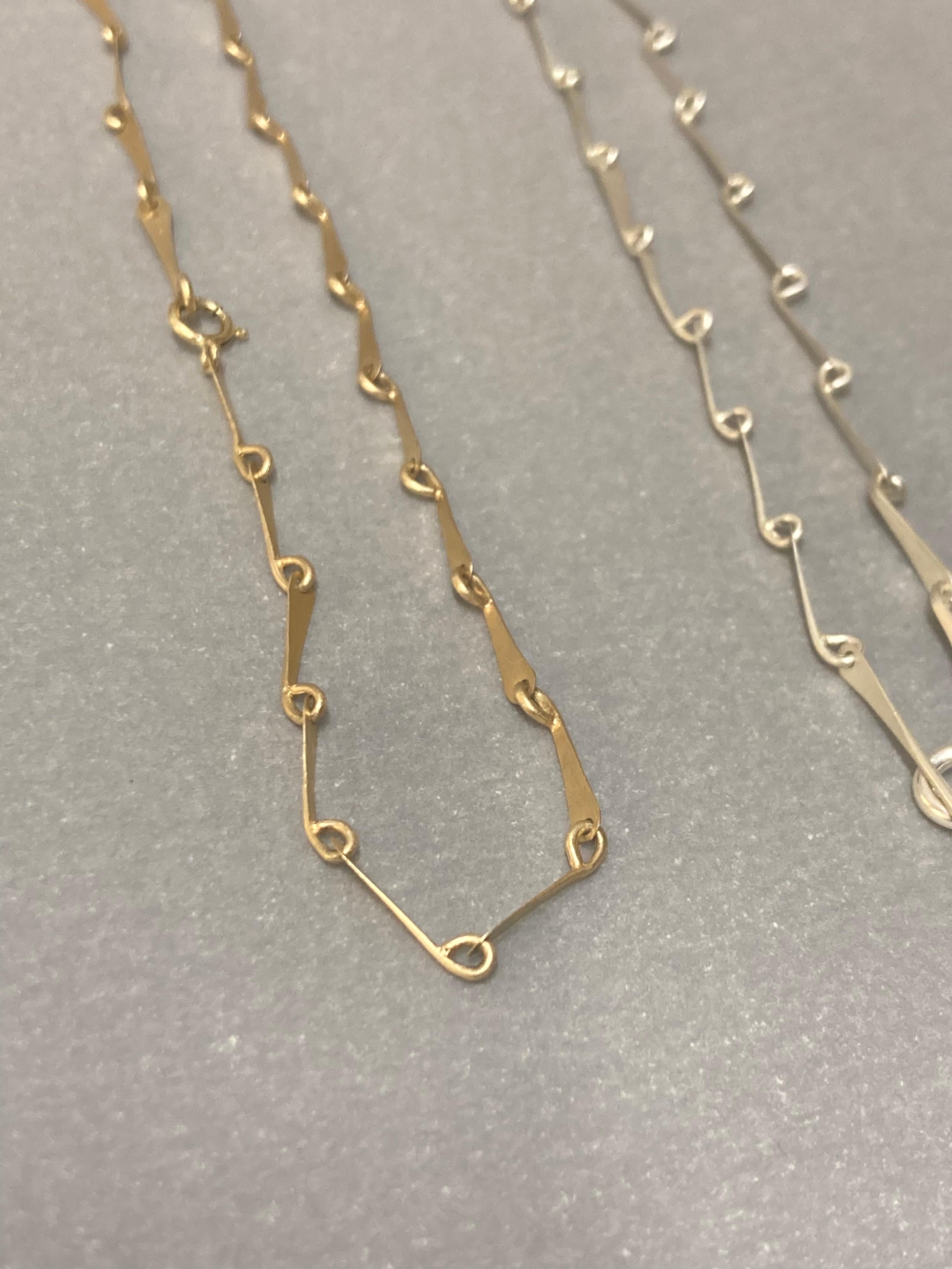 These lightweight chain is the perfect everyday piece. This flowy linked chain is inspired by the articulated legs of insects. 

It is intricately fabricated from 9ct recycled yellow gold forged links, and finished with a matte sheen to catch the
