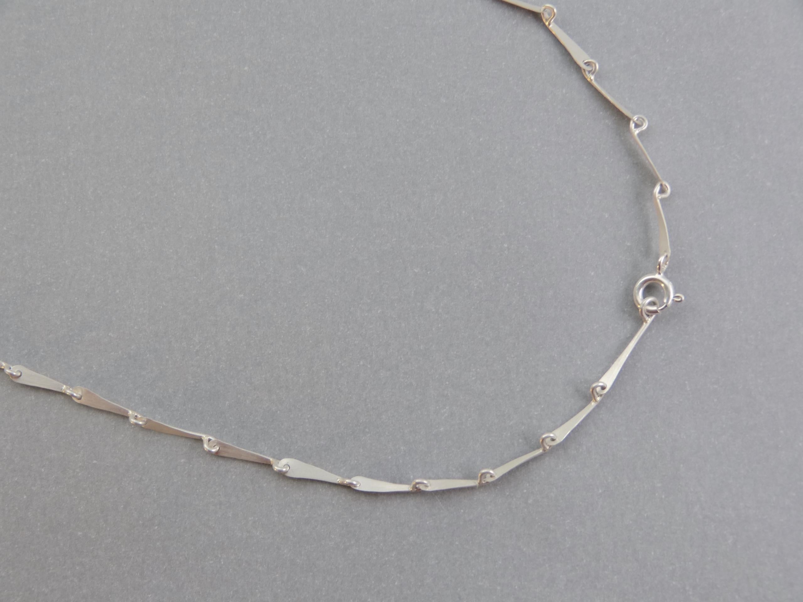 This lightweight handmade chain bracelet is the perfect everyday statement. Flowy delicate chain, inspired by the articulated legs of insects. 

It is fabricated from sterling silver forged links, and is finished with a matte sheen to subtly catch