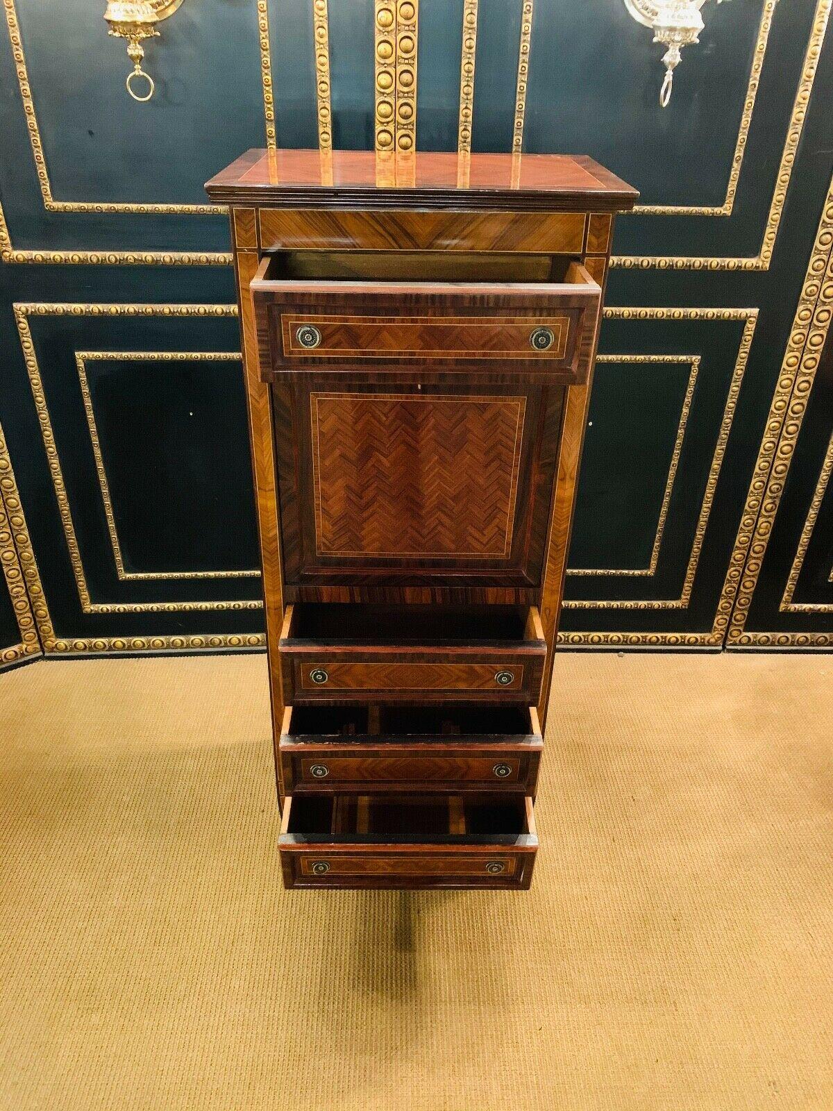 Veneer on solid softwood.

Rectangular body on pointed legs.

Straight flap in the front between four drawers.

Rich office layout behind.

The sides and the front have framed panels.

Adorned with parquet-like marquetry.