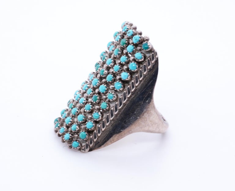 Delicate, Lovely, Vintage Native American Navajo Sterling with Bright Blue Turquoise Ring
55 count of 1.8mm tiny turquoise beads bezel set in sterling silver.  Lovely, thin, light delicate ring.  A true stunner.
Ring Size 8 US
Condition: Very good