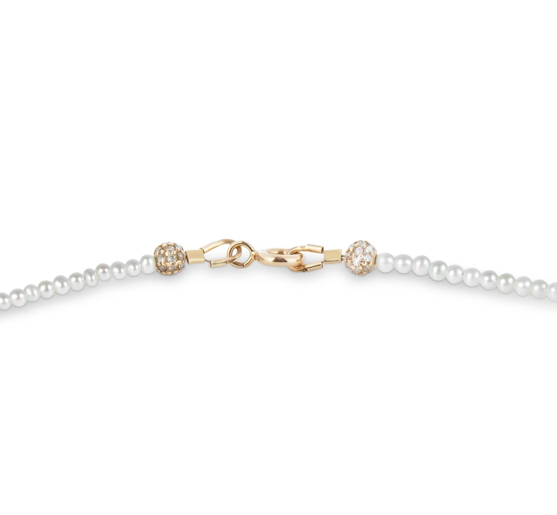 This delicate freshwater pearl necklace is made from AAA+ quality freshwater pearls with a beautiful luster. 
It has a 14K yellow gold clasp and two additional 14k diamond-encrusted beads for extra glamour. 
The necklace can be worn either way. With