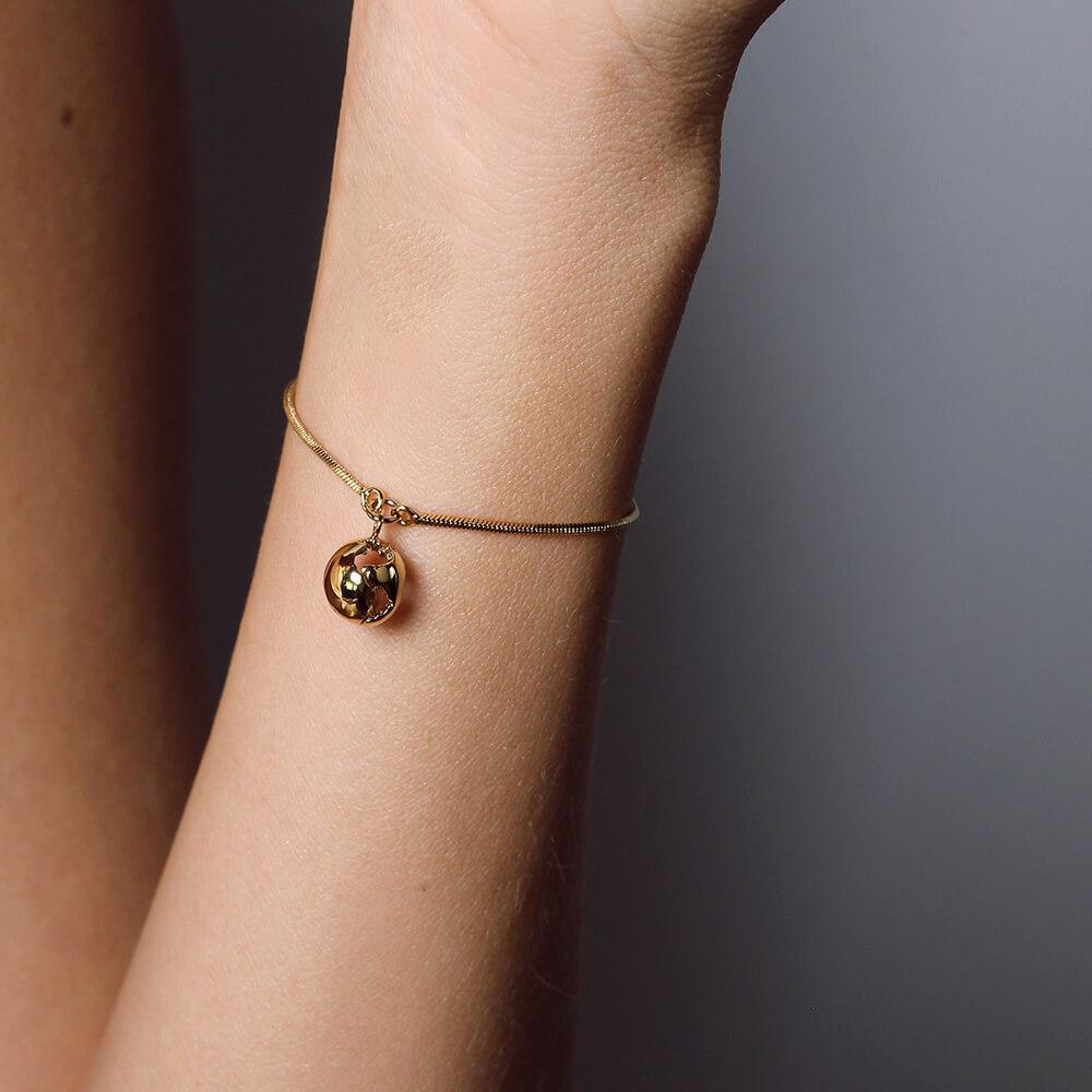 The World Charm Bracelet features a simple adjustable chain and an intricate world pendant of 1 cm. Available in  24k gold plated brass, the bracelet is perfect for an everyday look. Stack it with your favorite bracelets and add a special touch to
