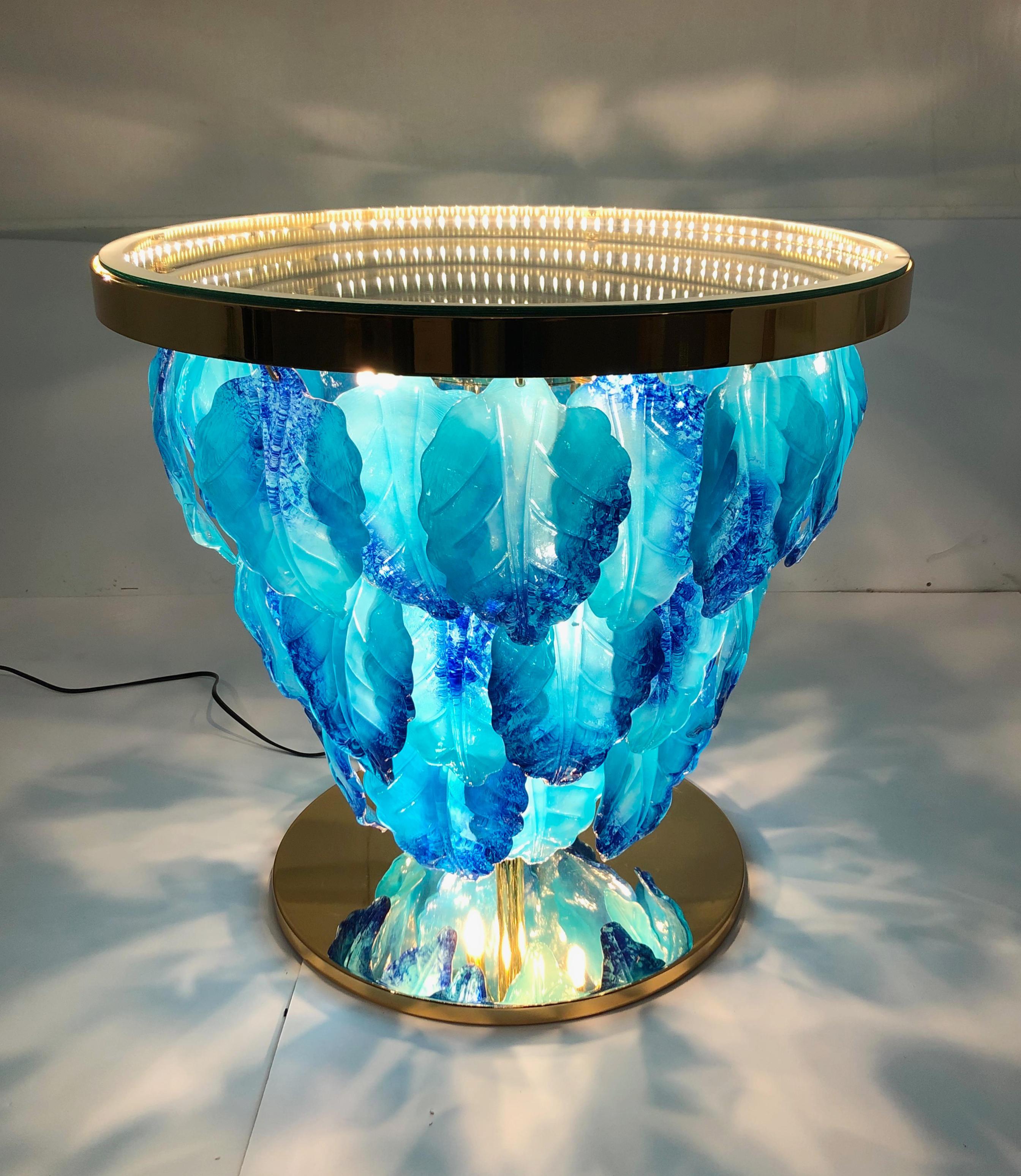 Modern Italian illuminated table with infinity lit mirror, dressed with blue and aquamarine Murano glass leaves mounted on 24K gold plated metal base / Designed by Fabio Bergomi for Fabio Ltd / Made in Italy
LED type lights
Diameter: 27.5 inches /