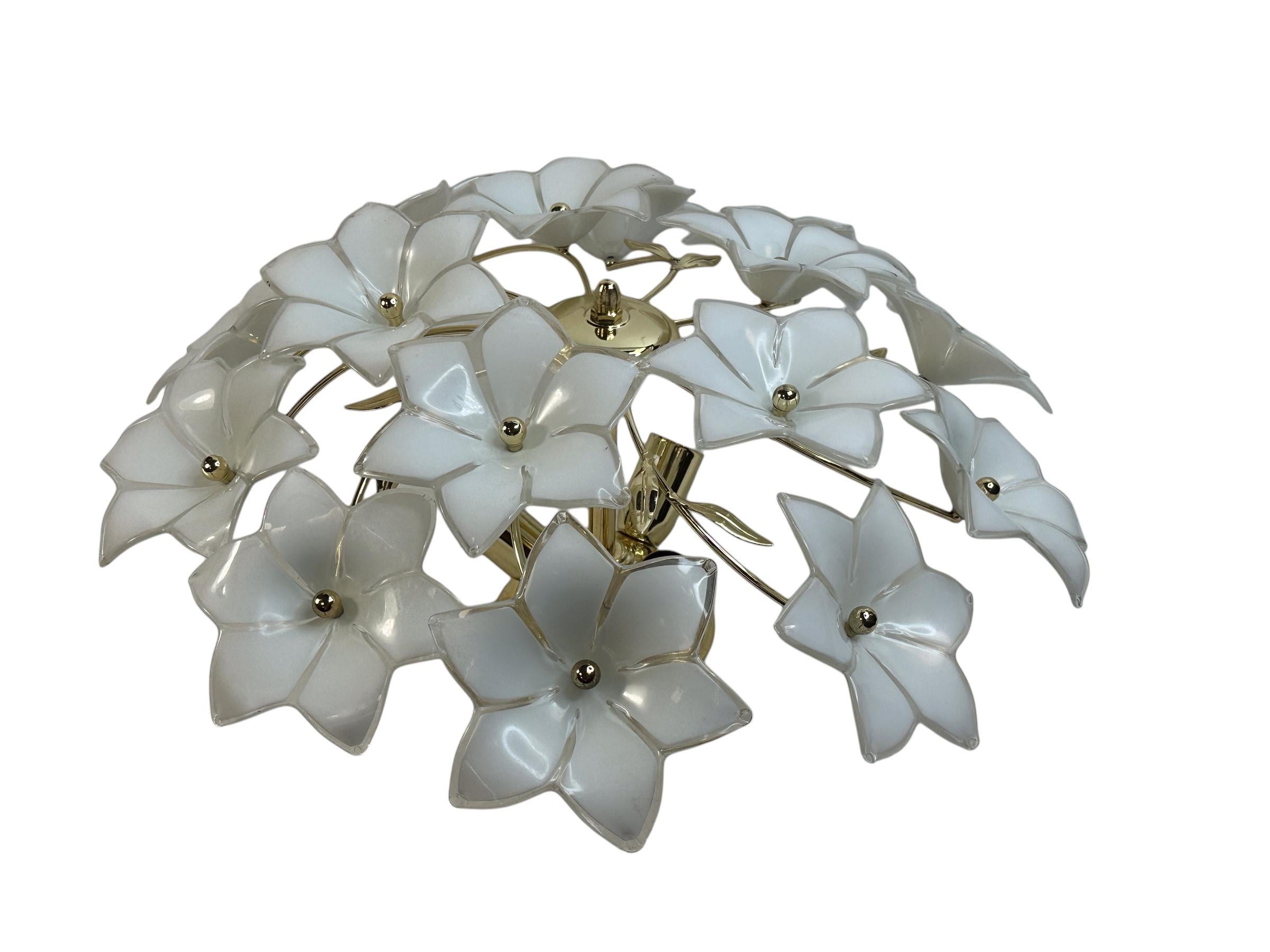 A beautiful flush mount ceiling light, made in Italy in the 1970s. Some beautiful glass flowers, hand made and therefor different in shape. The Fixture requires three European E14 / 110 Volt Candelabra bulbs, each bulb up to 40 watts.. It can also