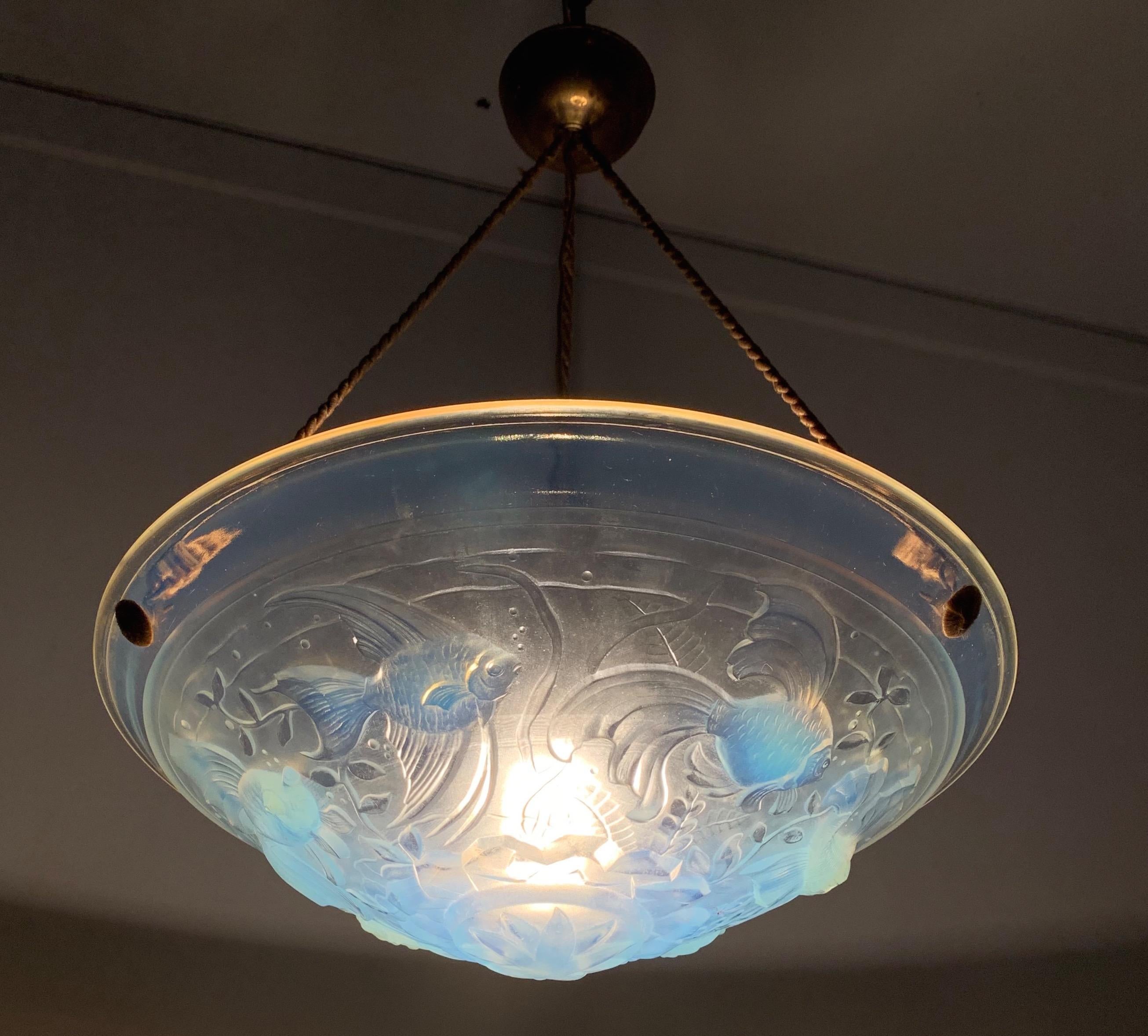 Very stylish and rare, 1920s Art Deco pendant light with a beautiful color.

When we first saw this rare, practical size and highly decorative Art Deco pendant we immediately knew it had to become ours. The wonderful design and shape immediately