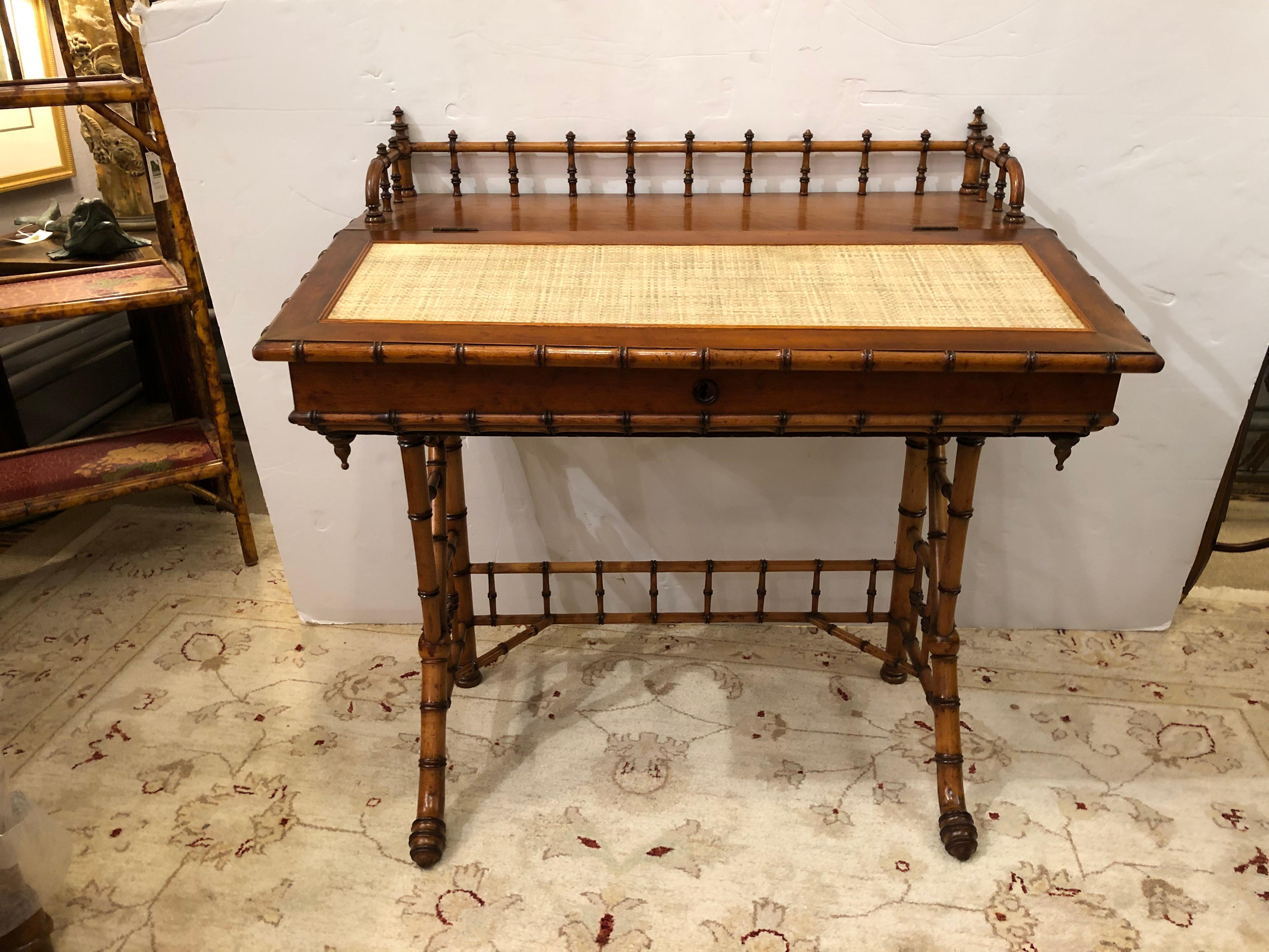 Beautiful vintage bamboo writing desk and matching chair having lovely craftsmanship with turned bamboo gallery around the desk top (34.75 h gallery, 30 h surface) and handsome grasscloth rectangle on the surface. Legs are wonderfully splayed with