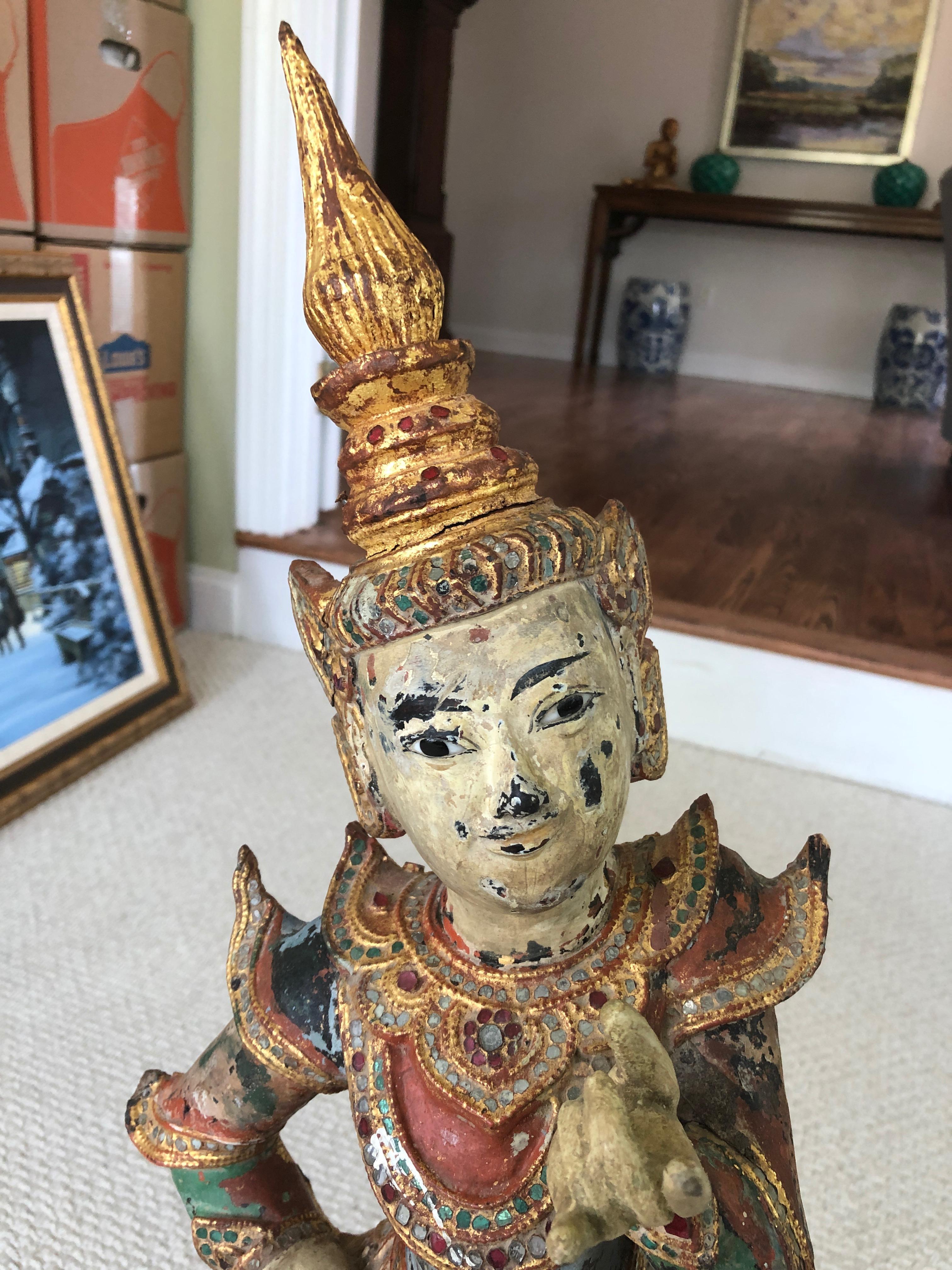 A charming Burmese dancing figure carved from wood and hand painted as well as gilded. The gestures are lovely in hands and feet, and the weathered condition adds to the character and proof of age.