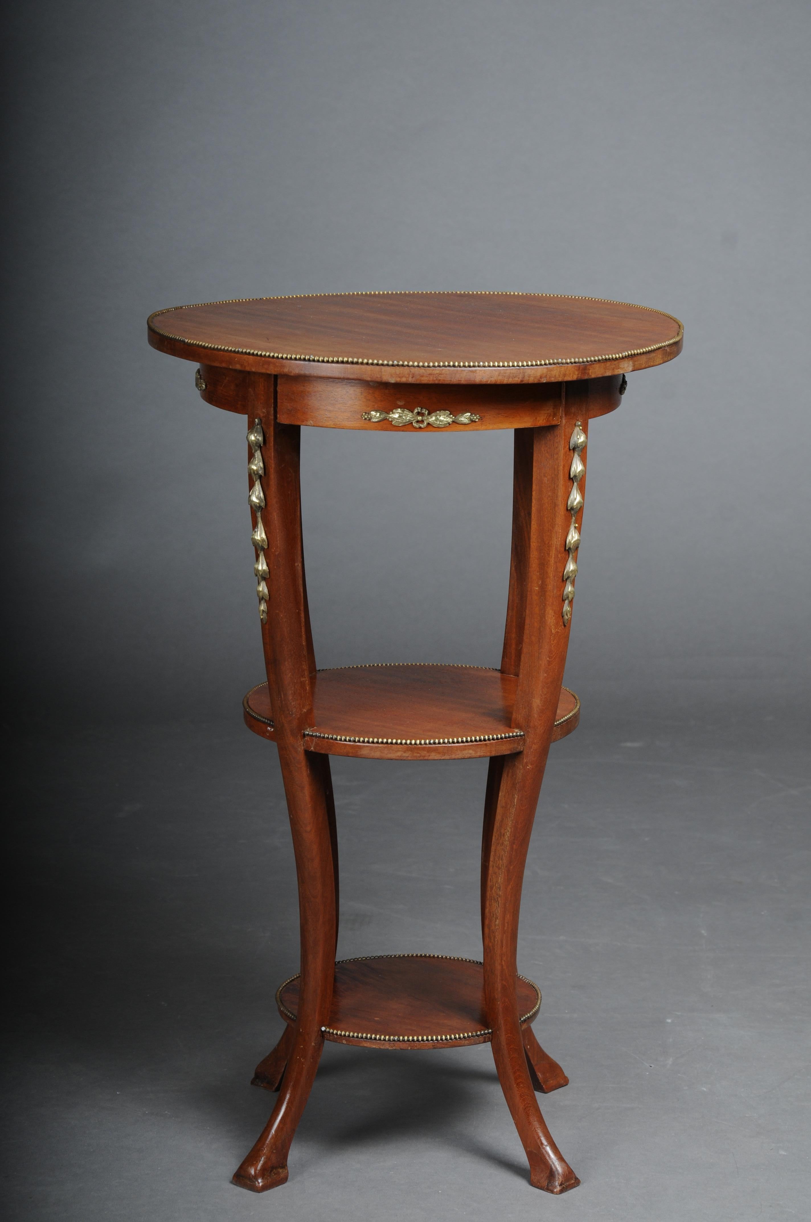 Delightful Empire side table, solid wood around 1910.

Solid wood mahogany side table on three floors. Elongated and slightly curved legs at the end. Entire body shod with brass accents. all three cover plates framed with pearl borders France