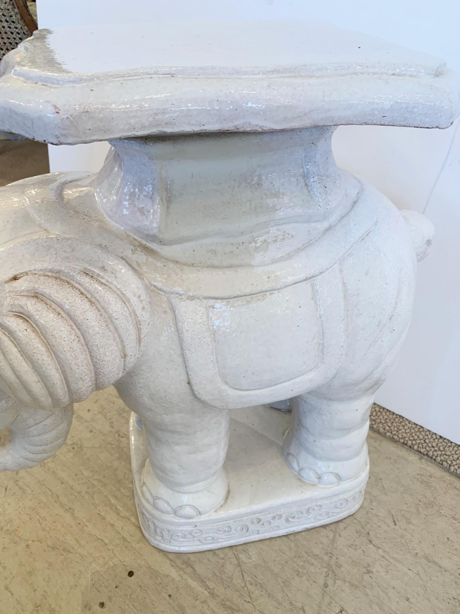 A handsome off white terracotta glazed elephant side drinks table having trunk in a curled up lucky position. A stylish accent table and perfect perch for a glass of wine.

  