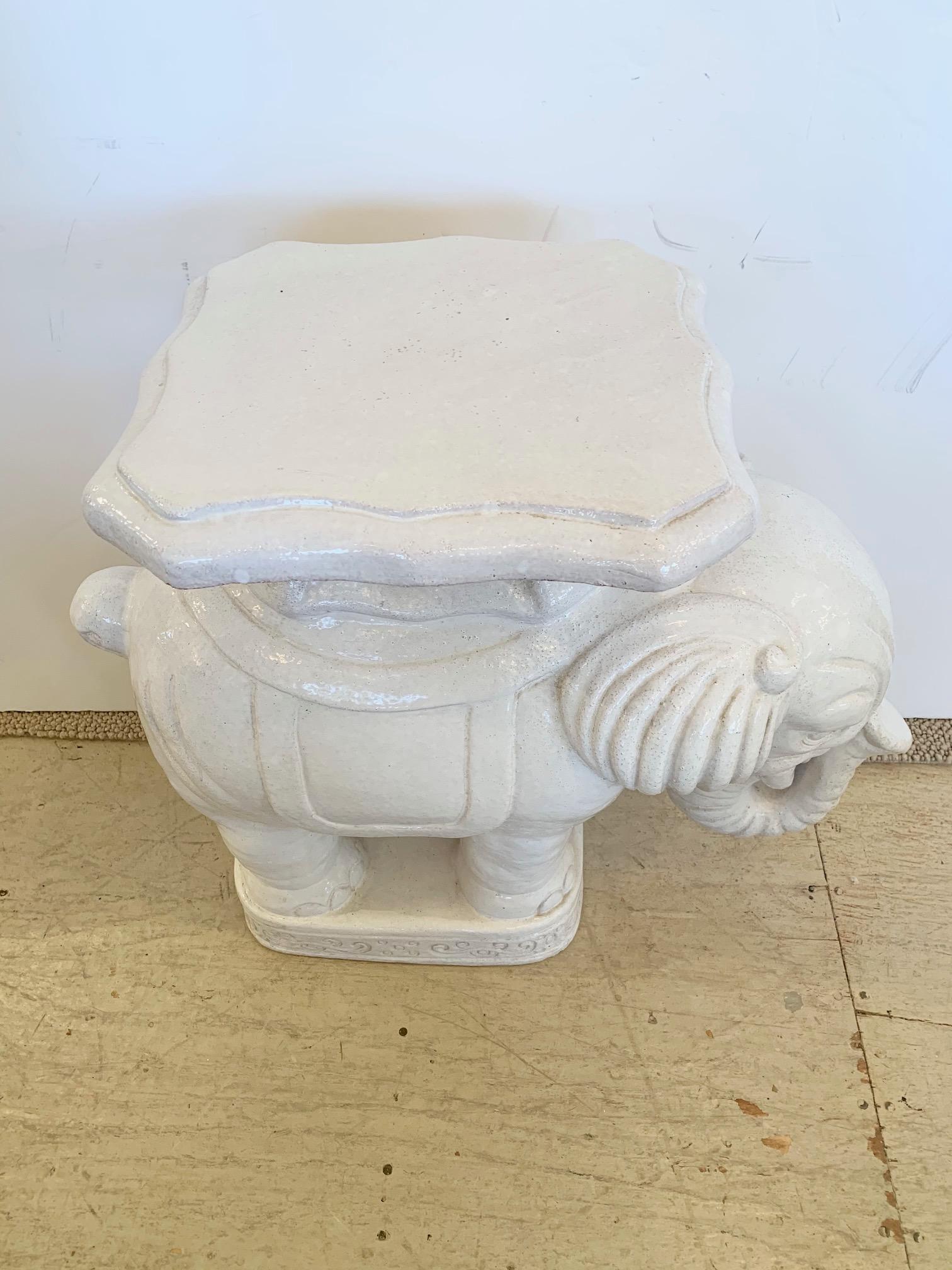 A handsome off white terracotta glazed elephant side drinks table having trunk in a curled up lucky position. A stylish accent table and perfect perch for a glass of wine.

 