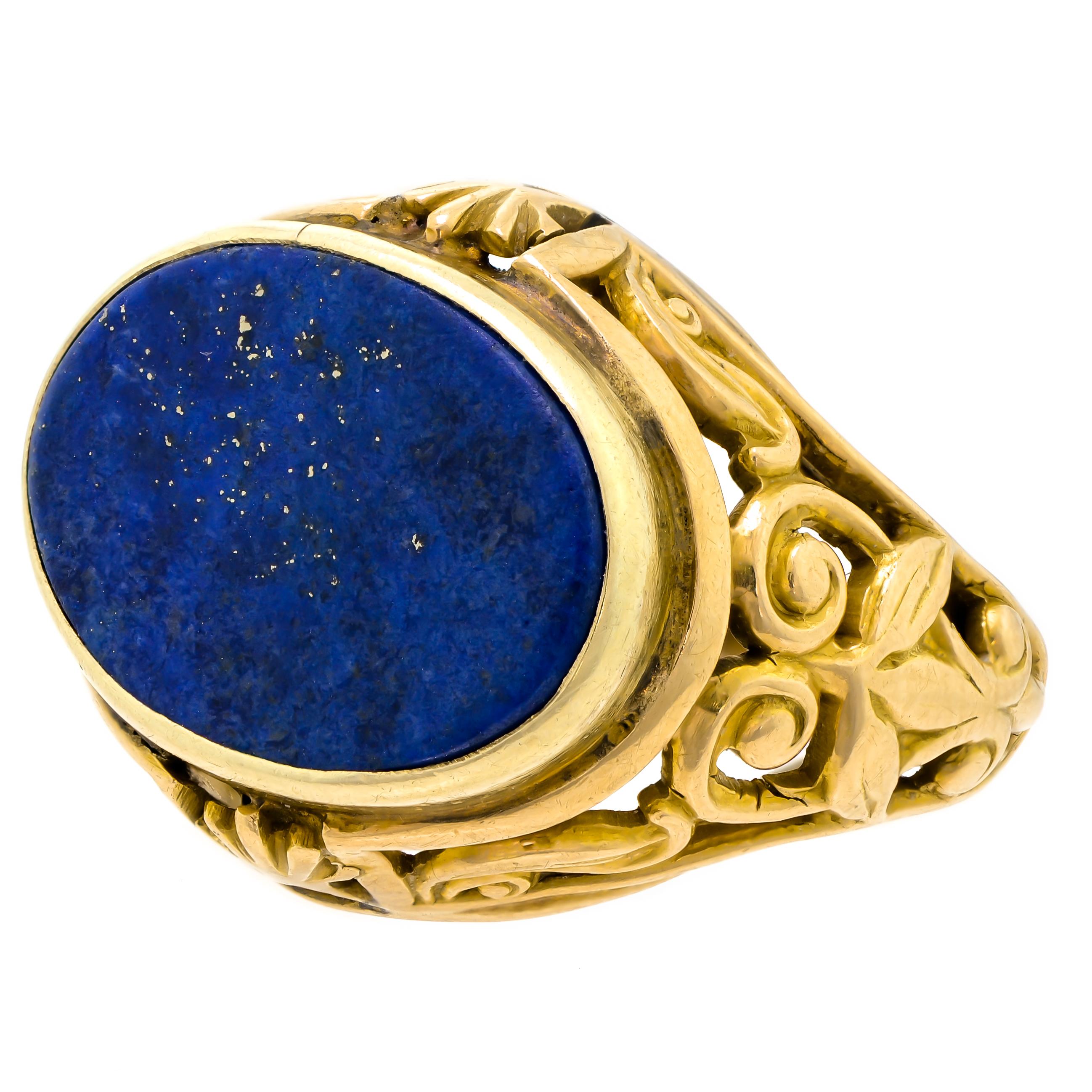 Attractive Victorian lapis ring crafted in 14kt yellow gold dating back to the 1900s. An artfully hand-engraved intricate design is depicted on each side of this stylized mount. Inside the magnificently adorned shank decorated with scrollwork, a 14k