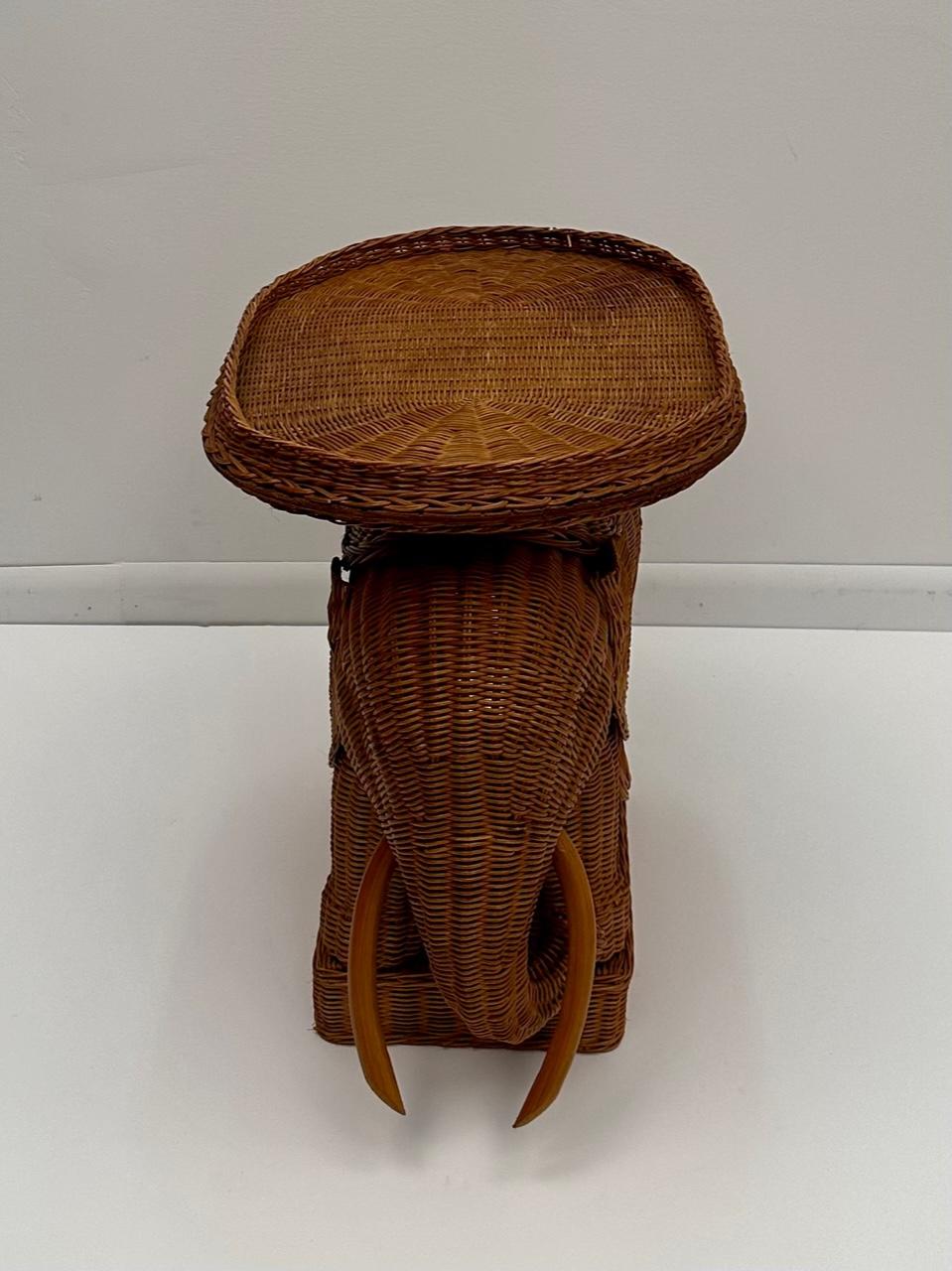 Stylish Mid-Century Modern natural wicker end table in the shape of an elephant having oval tray top (22.5 L x 16 D).