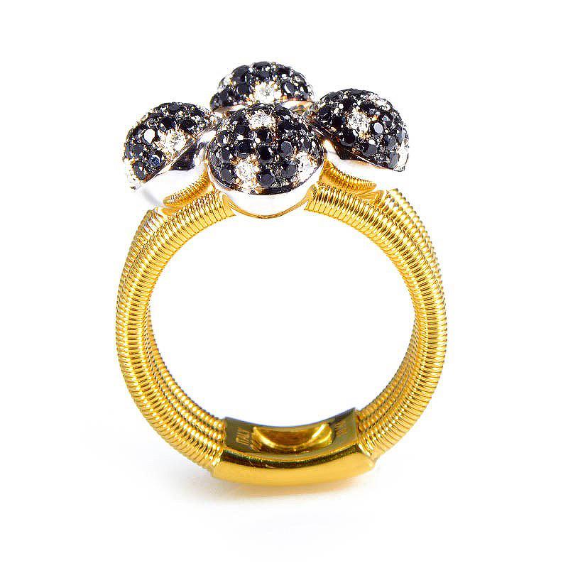 This ring from Della Riva is unique and lovely. It is made of 18K yellow gold and boasts a design of four diamond set spheres. The spheres are set with ~1.60ct of black and white diamonds.
