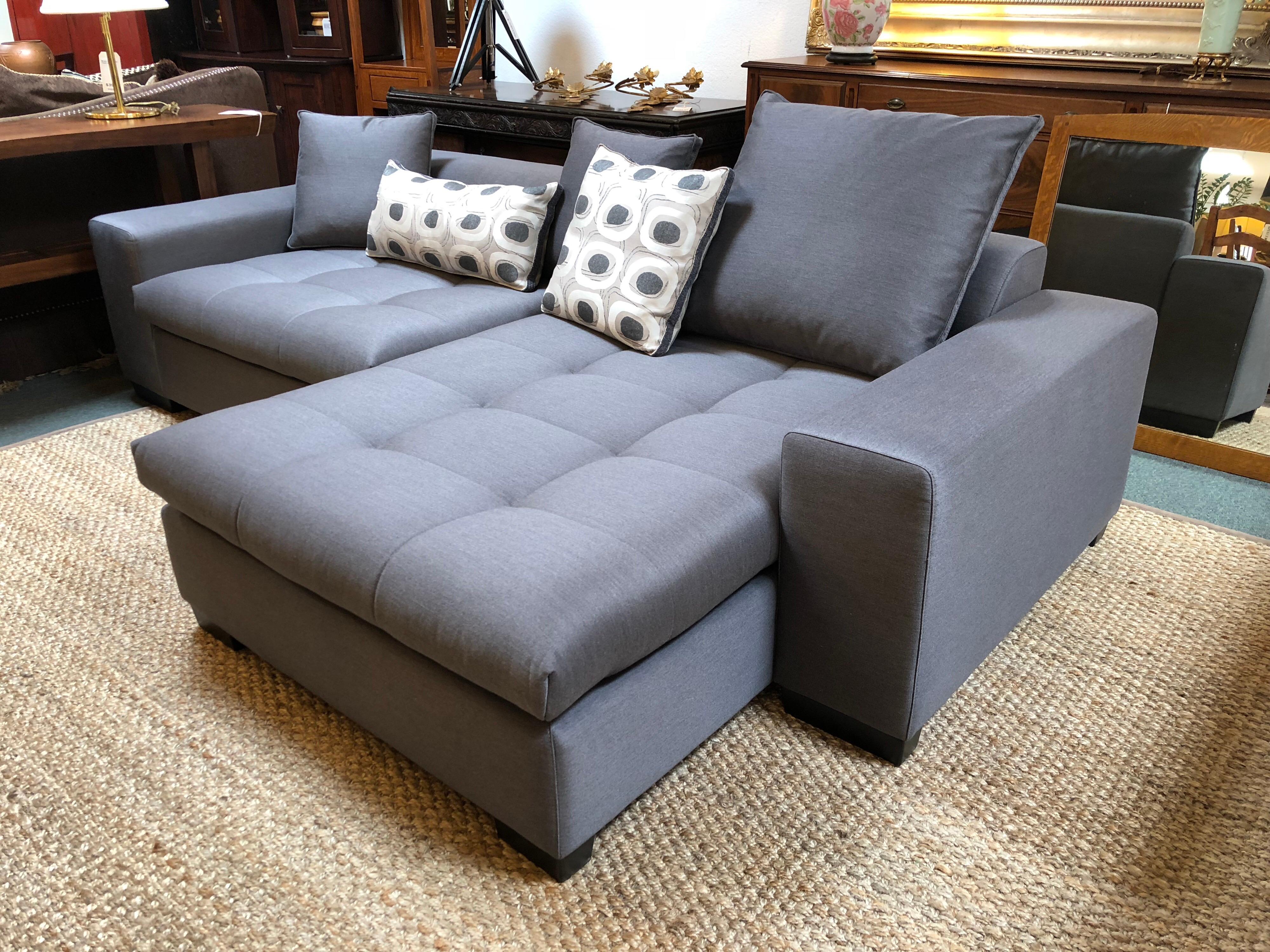 A Eureka Sectional by Della Robbia. This two-piece invites lounging, with soft tufting, down and feather cushions and wide arms. Crafted of hardwood with 3