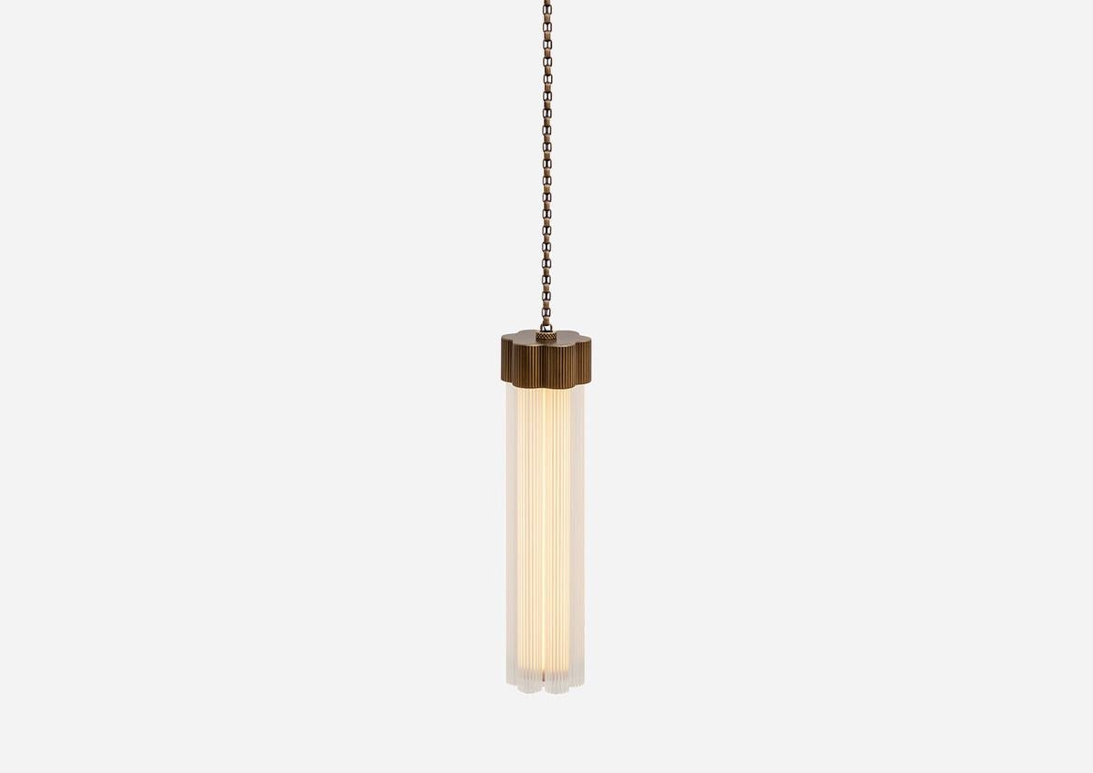 Delphi, a versatile new lighting collection designed by Jamie Gray, is constructed of cast and machined brass paired with fluted glass tubing, paying homage to iconic Greek columns. The proprietary brass chain allows for a variety of lighting