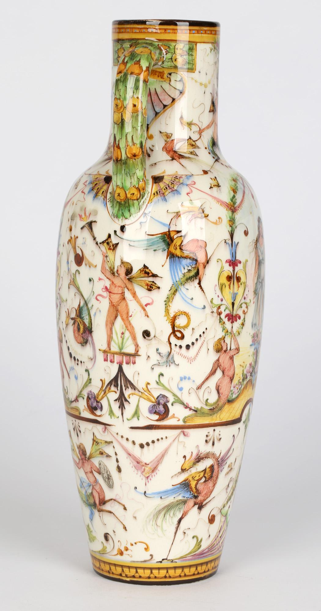 An exceptional and rare French Vallauris twin handled majolica vase hand painted with classical style figures by Delphin Massier and dating from around 1890. This tall and elegant slender vase is lightly potted with a rounded bulbous body tapering