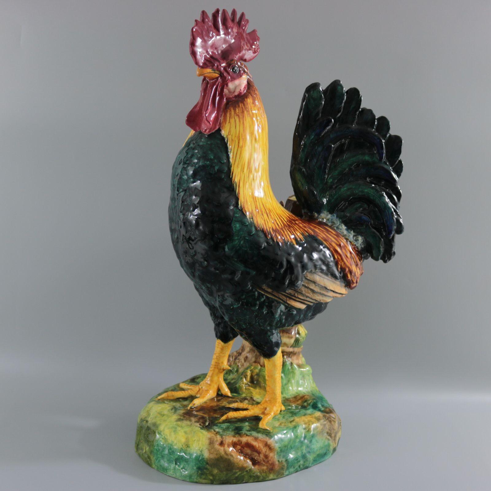 Delphin Massier French Majolica figural vase which features an exquisitely colourful rooster / cockerel, standing in front of a bamboo-effect vase. Colouration: yellow, teal blue green, are predominant. The piece bears maker's marks for the Delphin