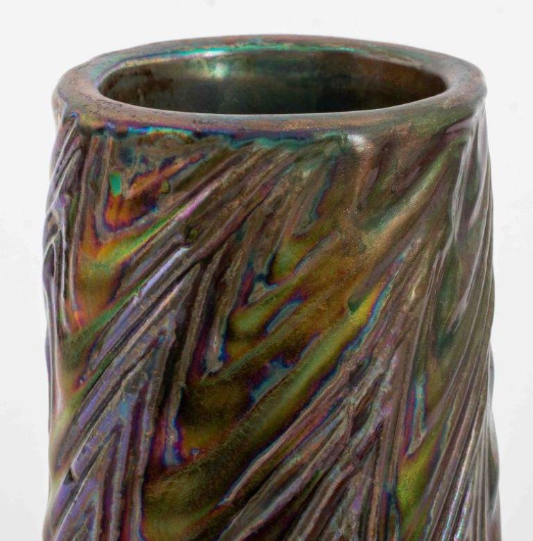 Delphin Massier (French, 1836-1907) Art Nouveau iridescent glazed ceramic earthenware vase, circa 1900, the tapering cylindrical form molded with swirling ribbing, glazed in red with silvery blue iridescence, signed 