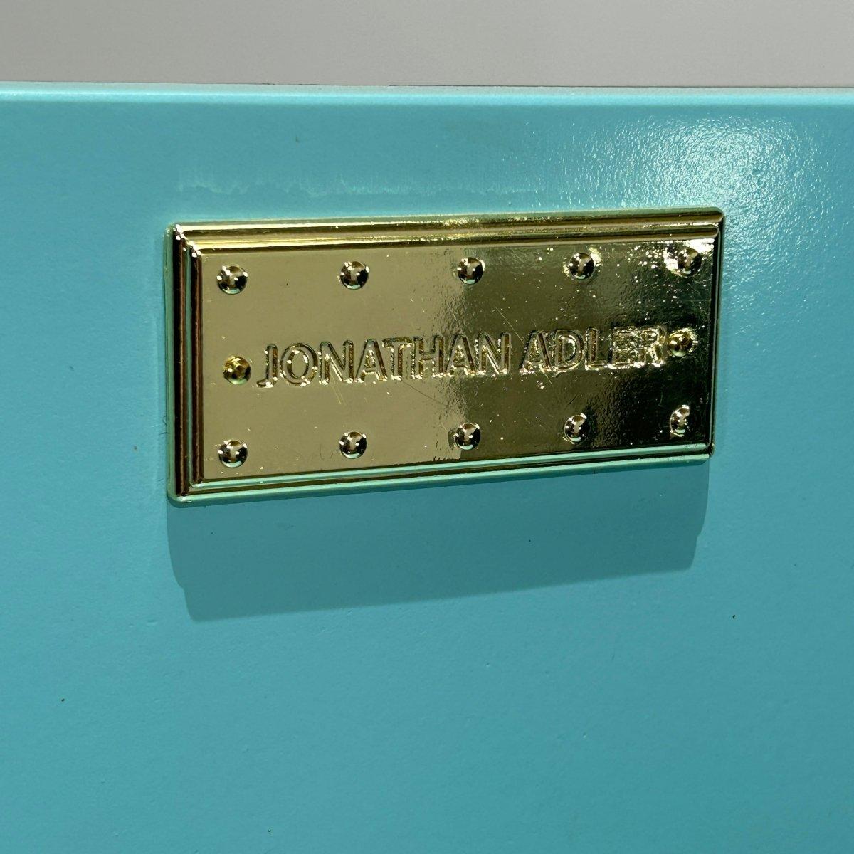 Introducing the Delphine Bar by renowned designer Jonathan Adler. This stunning piece is a true statement of luxury and sophistication, perfect for any modern home. Crafted with the finest materials, including a sleek metal frame and a beautiful