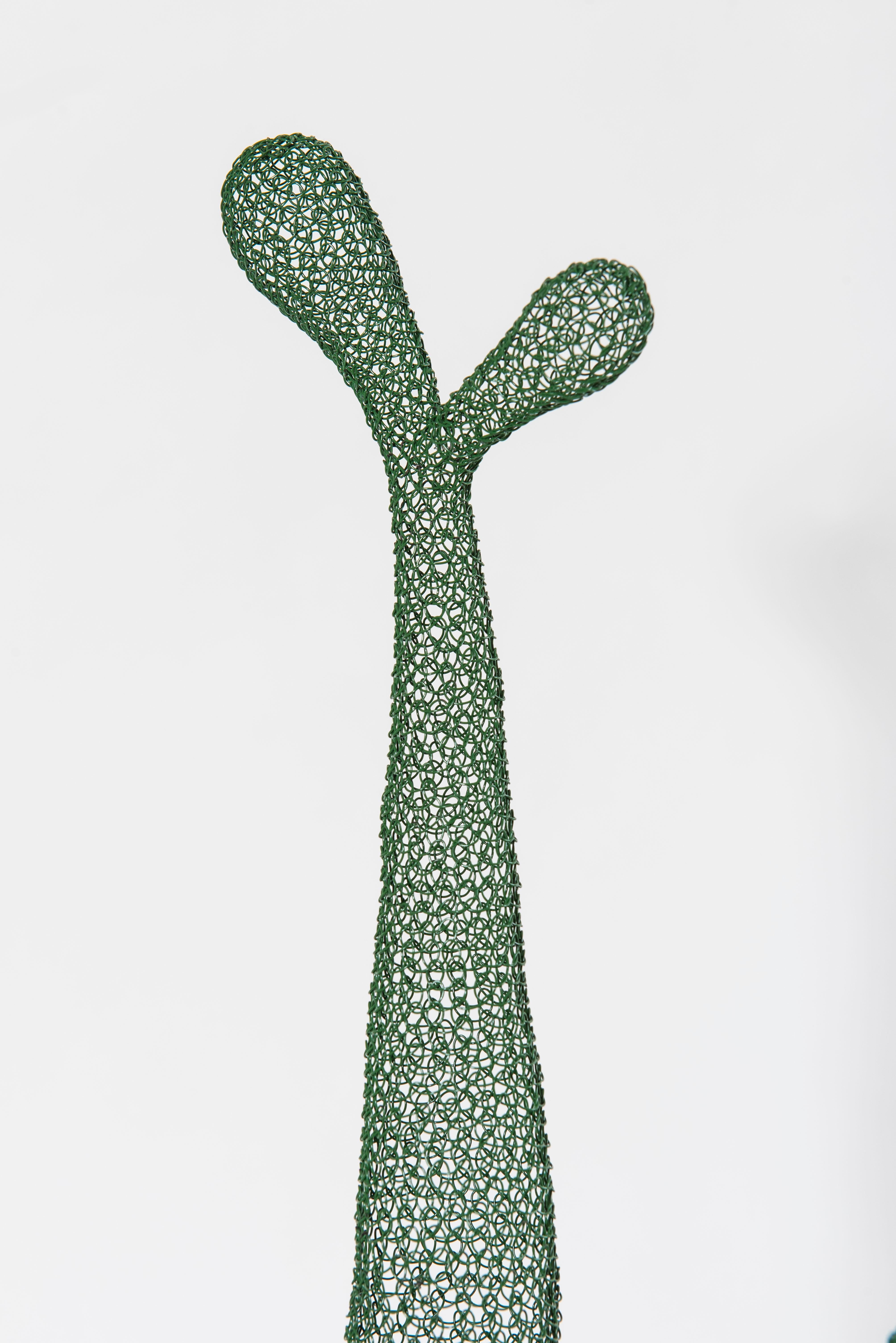 This mesh-work sculpture named « 6 Cactus » is entirely hand-knitted from a single metal wire plasticized in green. It was created and made by artist Delphine Grandvaux. This work consists of six similar and independent parts, each of which