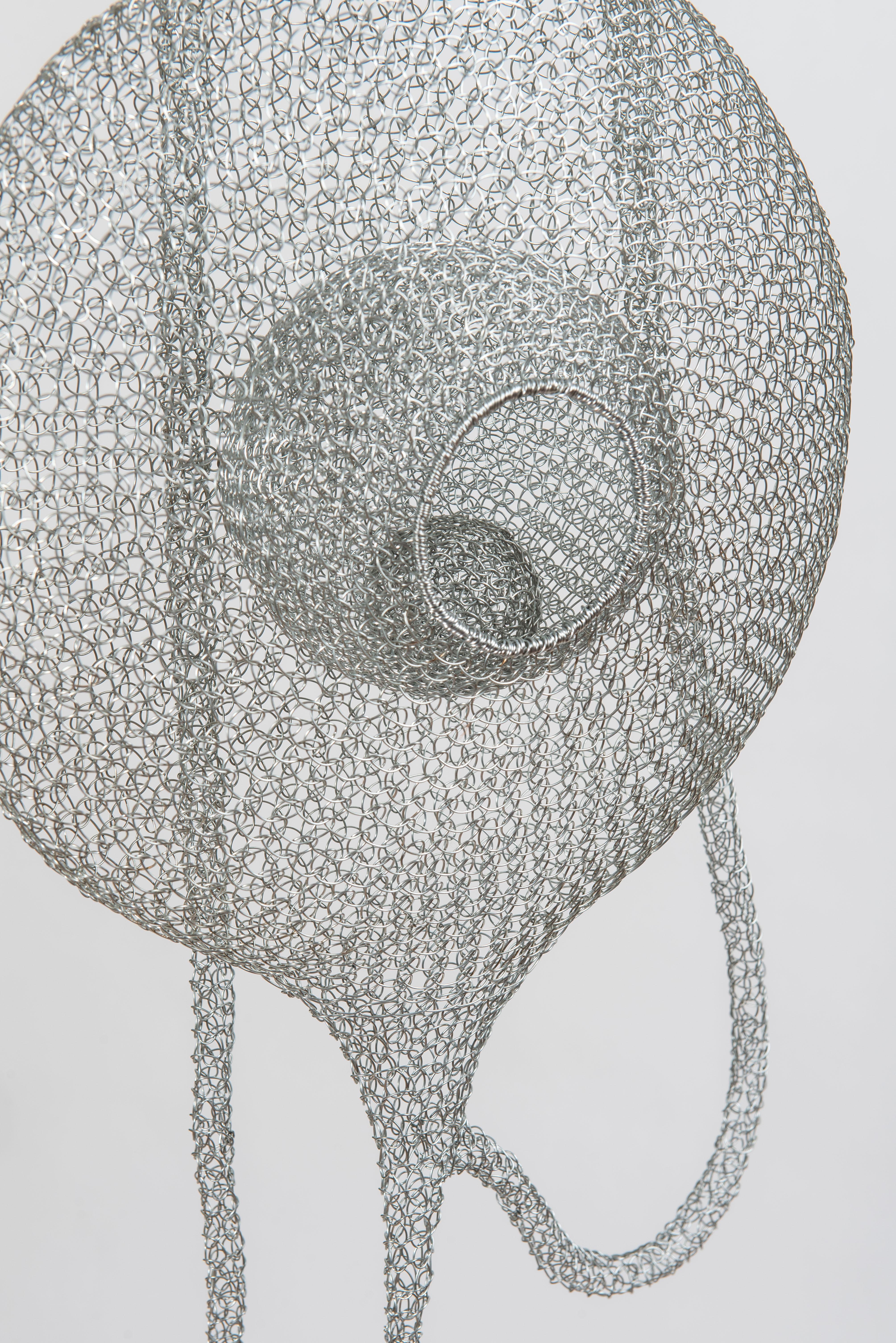 An airy meshwork of aesthetic shapes combining with felted green wool, this sensual sculpture named « Safe harbor I» is created and entirely handmade from silver-grey galvanized iron wire and felting wool by artist Delphine Grandvaux. The artist