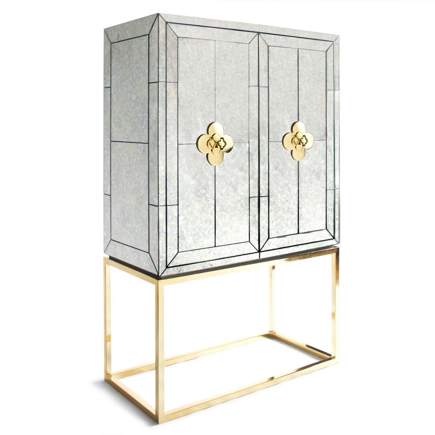 Minimalist forms meet Maximalist glamour. Antiqued mirror with a polished brass base. The robin's egg blue interior is fitted with four adjustable tempered glass shelves, plus six wire-bound drinking glass shelves inside the doors. Two drawers at