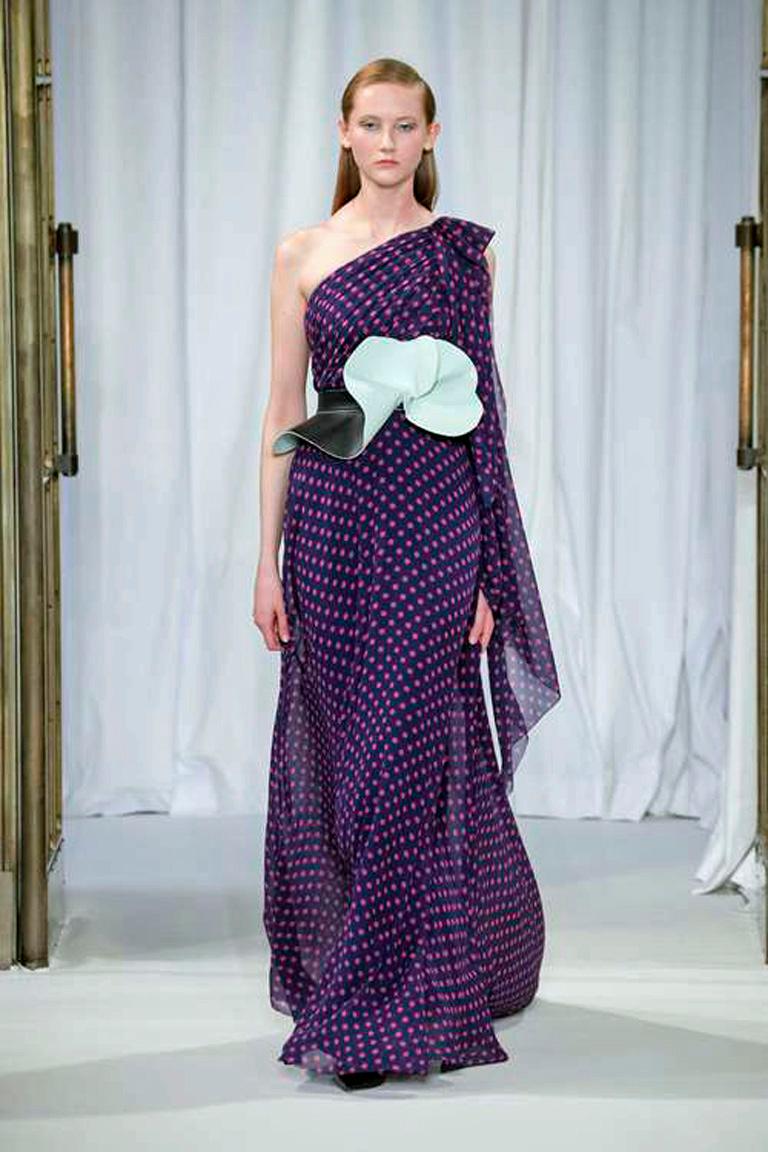 A dreamy entrance gown in soft purple polka dot by Delpozo.   A one shoulder fitted  bodice and waist extending into a full dramatic skirt.  Beautifully crafted and designed soft leather two-tone flower belt completes the look.  Size zipper closure.