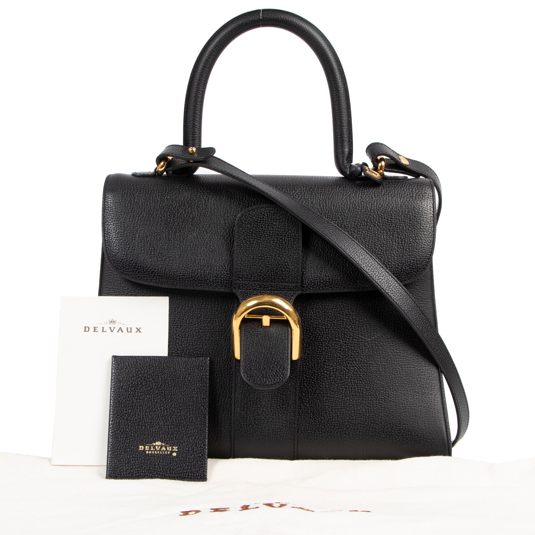 Insert some Belgian heritage into your wardrobe with this stunning Delvaux Brillant bag. This gorgeous top handle bag is a timeless classic that will never go out of style due to its sleek shape and versatile color. This Brillant bag comes in black