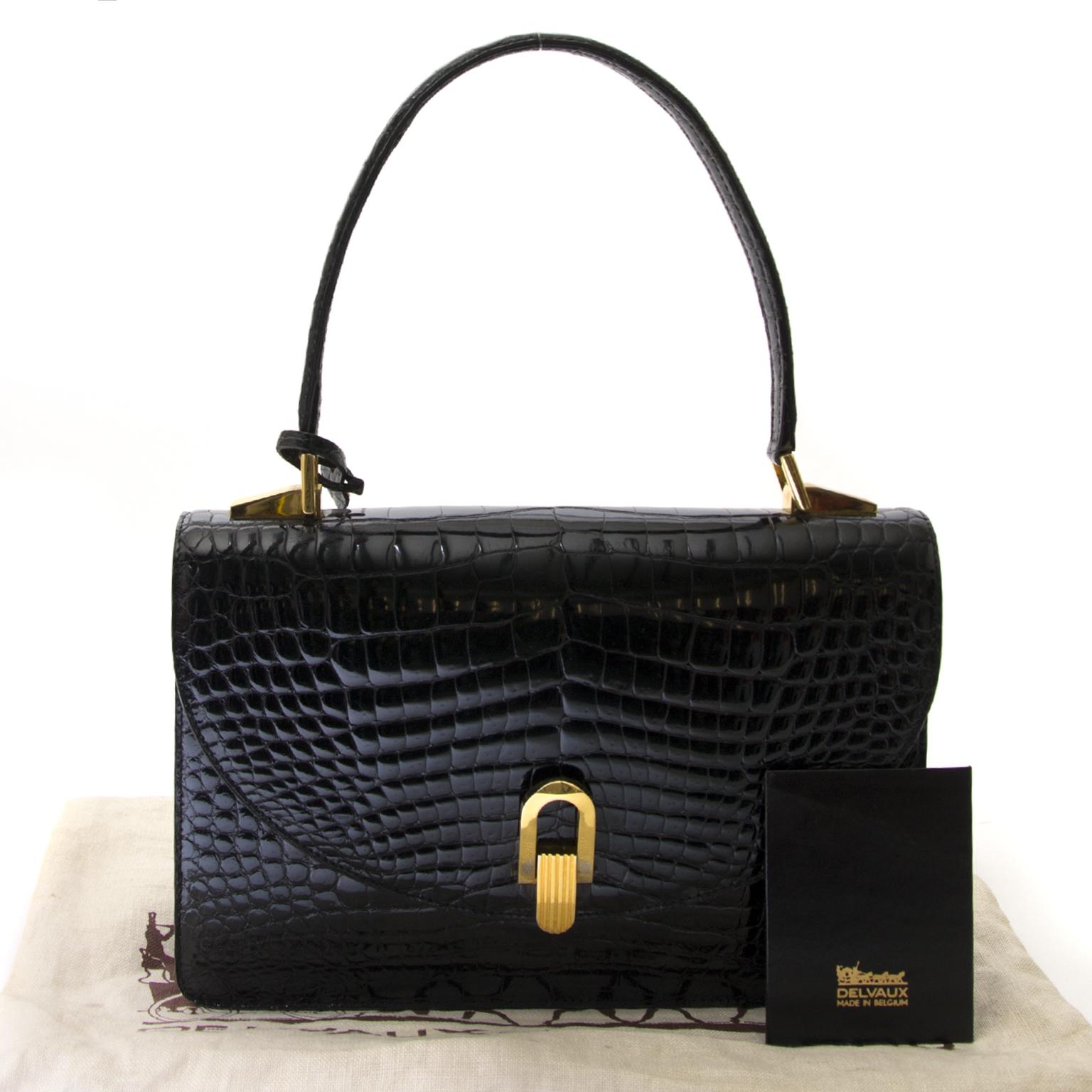 Good preloved condition

Delvaux Black Croco Handbag

This gorgeous handbag by Delvaux is a truely unique designer piece.
The bag is crafted in black croco leather and features gold-tone hardware.
It opens with a flap and a push button, that gives