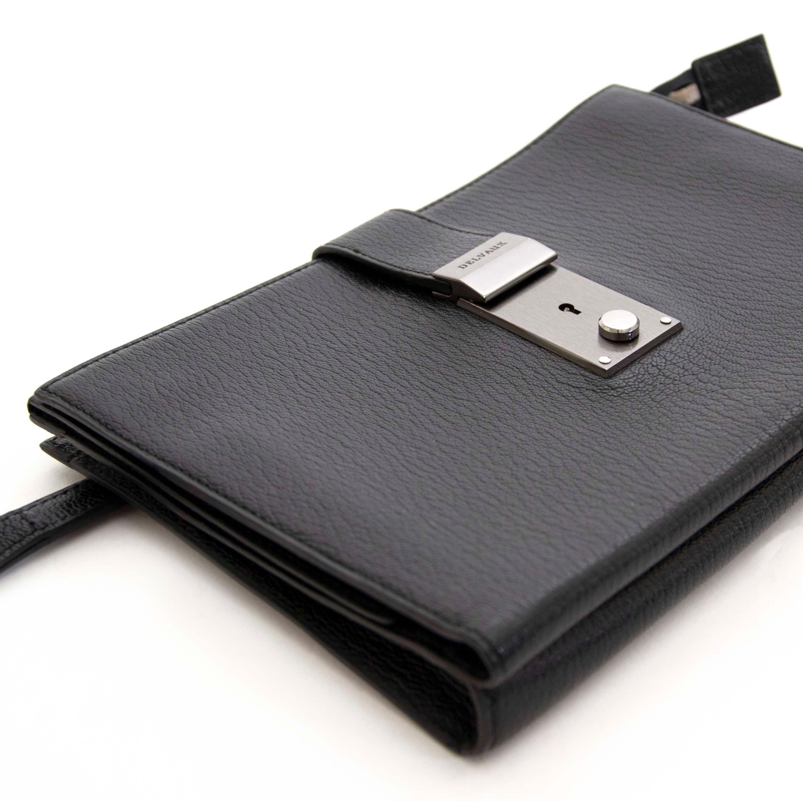 Very good preloved condition

Delvaux Black Leather Pochette

Store your essential documents in this leather pochette, or wear as a clutch with your evening ensemble.

This pochette has two big compartments. One opens up in with a lock, the other