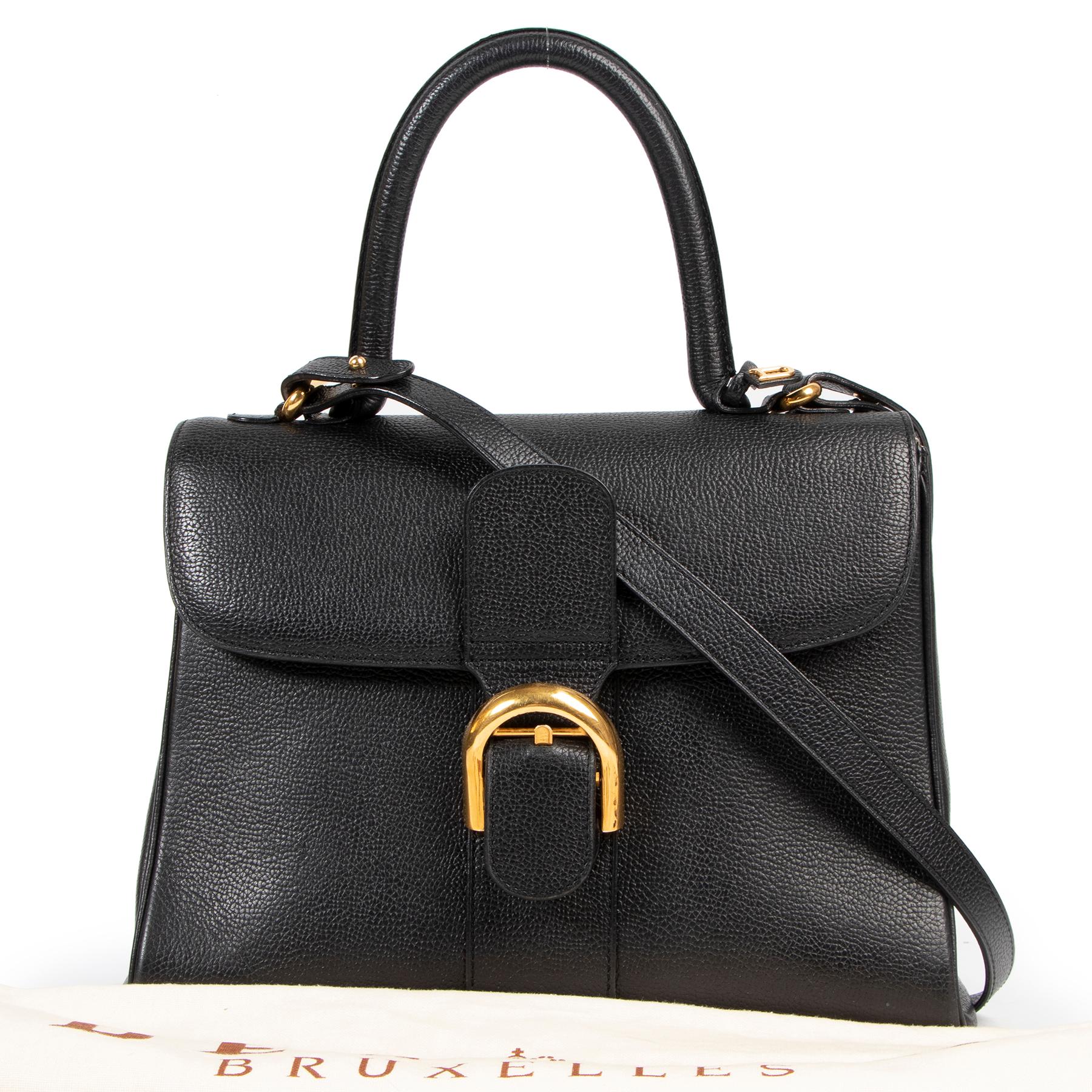 Very good condition

Delvaux Brillant Black MM + Strap

The iconic Delvaux Brillant in timeless black pebbled leather with gold toned hardare. The bag has a detachable shoulder strap and can be worn cross body.

The interior of this beauty features