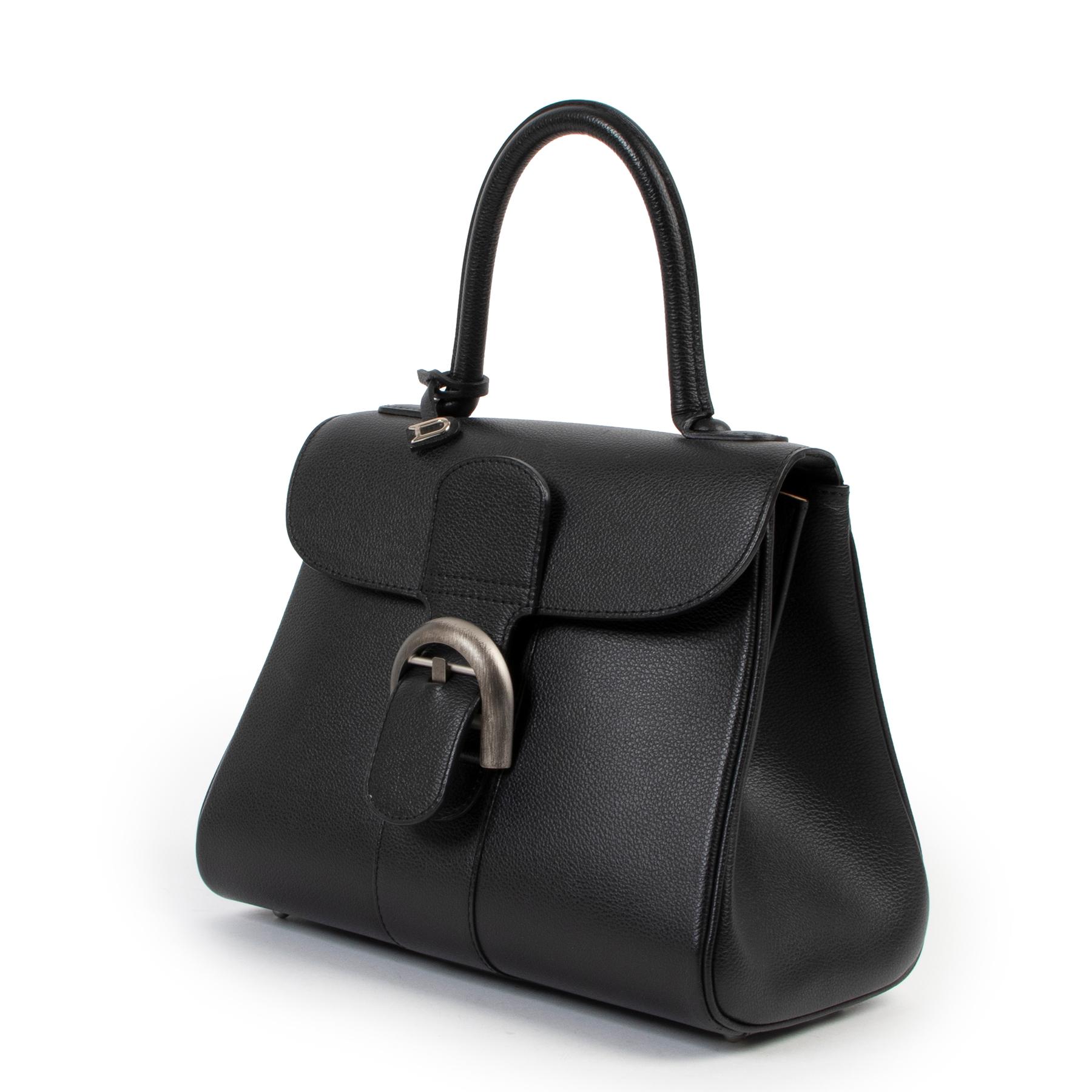 Delvaux Brillant PM Jumping Black Handbag

With the unmistakable shape and the buckle like a gem, the Brillant is the true icon of the house of Delvaux. This elegantly compact PM size in timeless black shows that small is beautiful, enough for all
