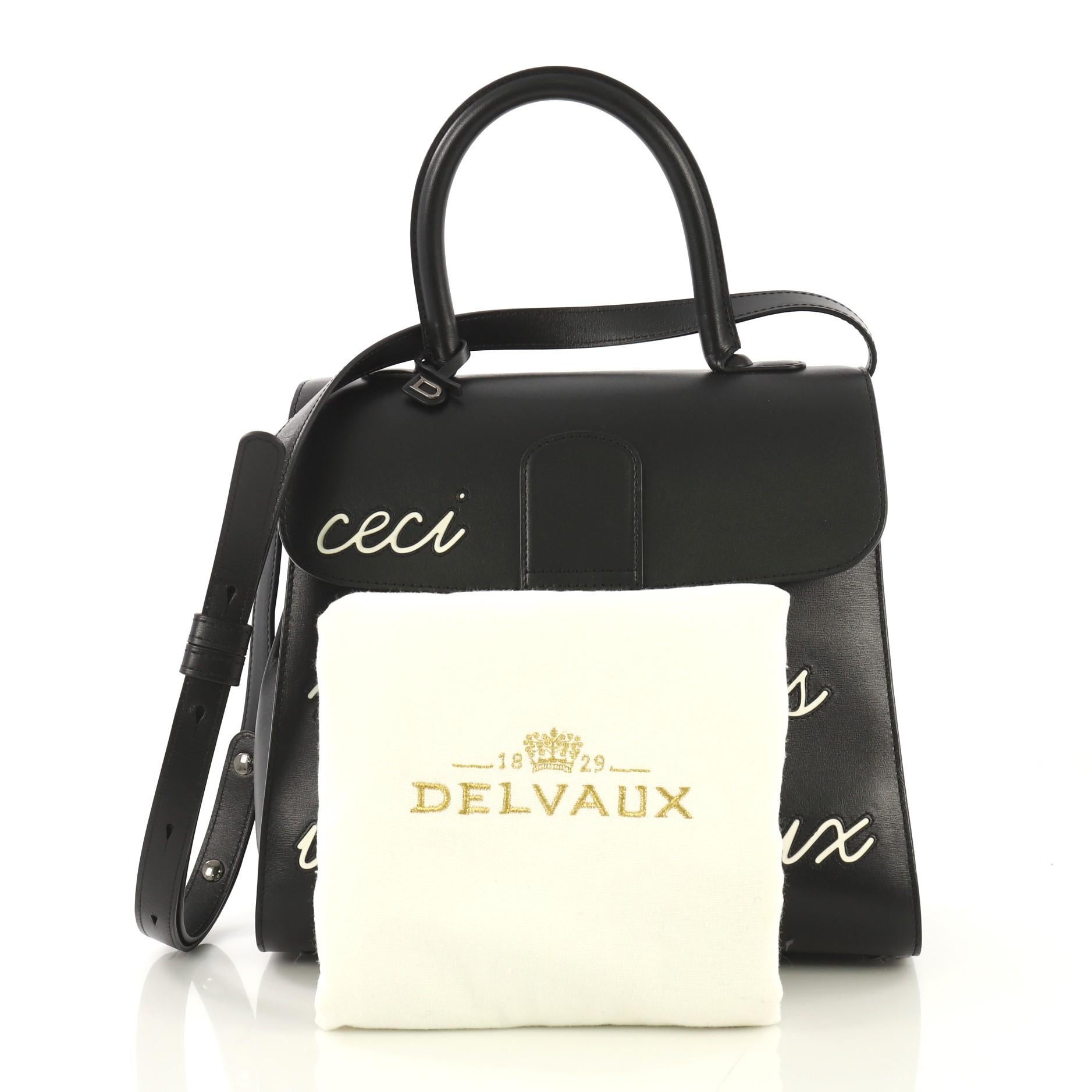 This Delvaux Brillant Top Handle Bag Limited Edition Leather MM, crafted from black leather, features rolled leather top handle, stylized 