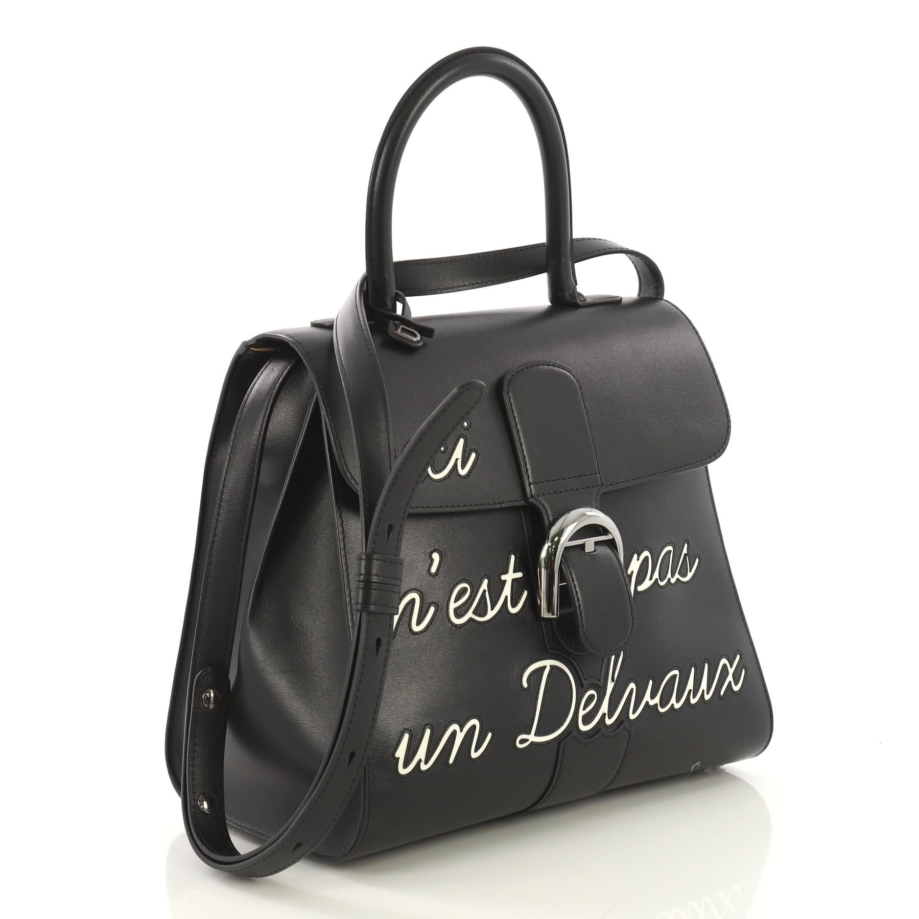 This Delvaux Brillant Top Handle Bag Limited Edition Leather MM, crafted from black leather, features rolled leather top handle, stylized 