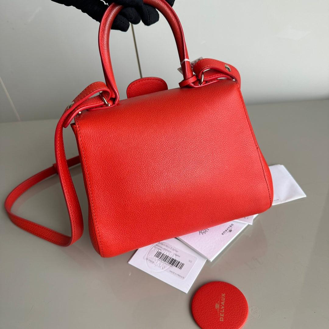 Delvaux Brilliant Mini Bright Red Calfskin Leather Crossbody Bag
  These are professional photos of the actual bag offered by Luxbags.
  Discontinued in 2015, the Grand Shopping tote bag is one CHANEL rarity that is highly treasured. This version