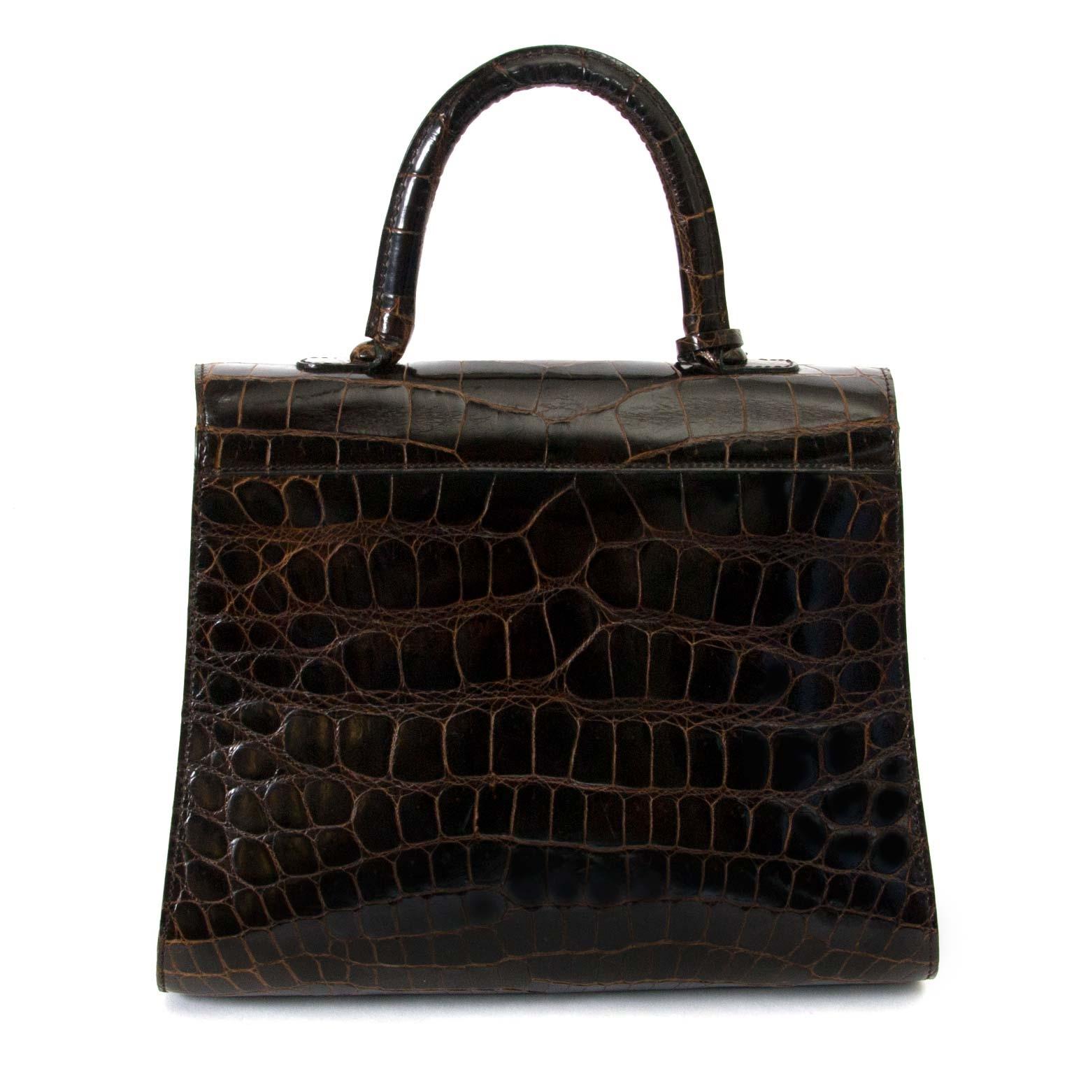 Very Good Preloved Condition

Delvaux Brown Croco Brillant MM

This iconic Delvaux bag comes in beautiful hunny brown shiny croco leather and is finished with gold-tone hardware.
The front flap contains the classic horseshoe belt buckle to open the