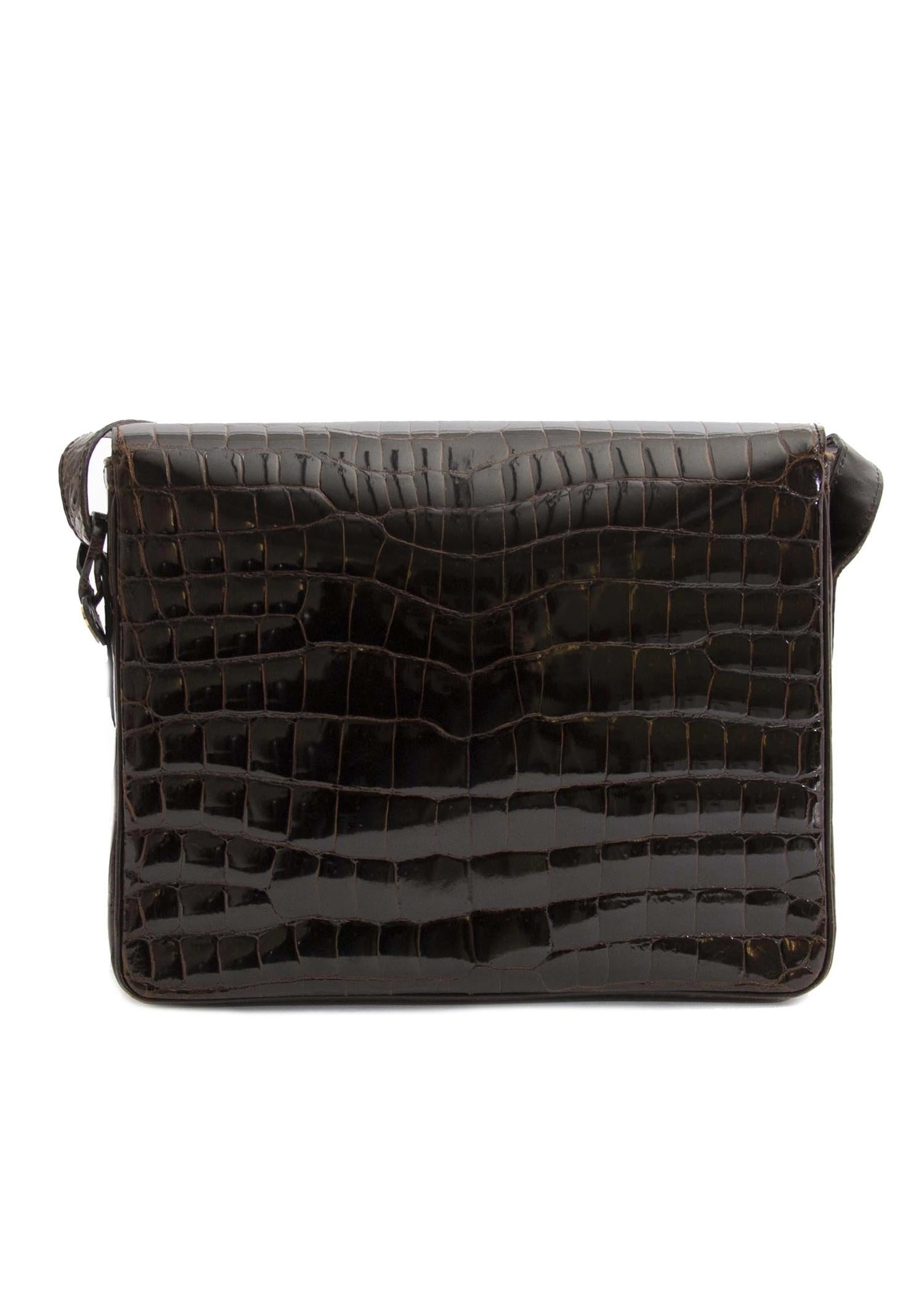 Very Good Preloved Condition

Delvaux Dark Brown Croco Passerelle Shoulder Bag

This timeless and practical Delvaux Passerelle Shoulder Bag exudes class. It's crafted from beautifull shiny croco leather and features the iconic D signature. The