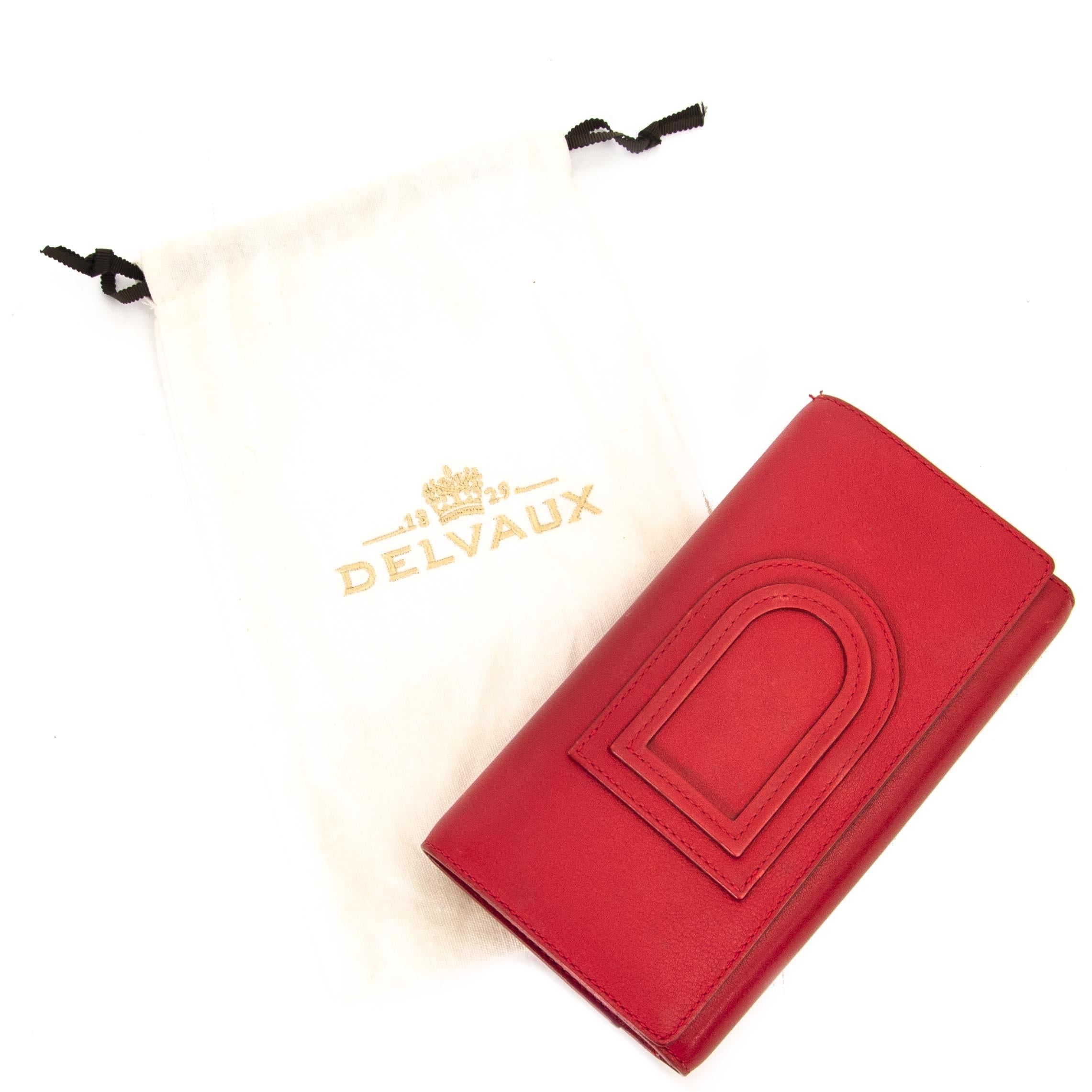 Good preloved condition

Delvaux Lipstck Red Trifold Wallet

This trifold wallet comes in a lovely bright red color and is crafted out of a soft smooth leather. 
The wallet opens with a push lock button. The inside features 12 card slots, a zip