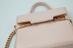 Delvaux nano handbag in baby pink leather.