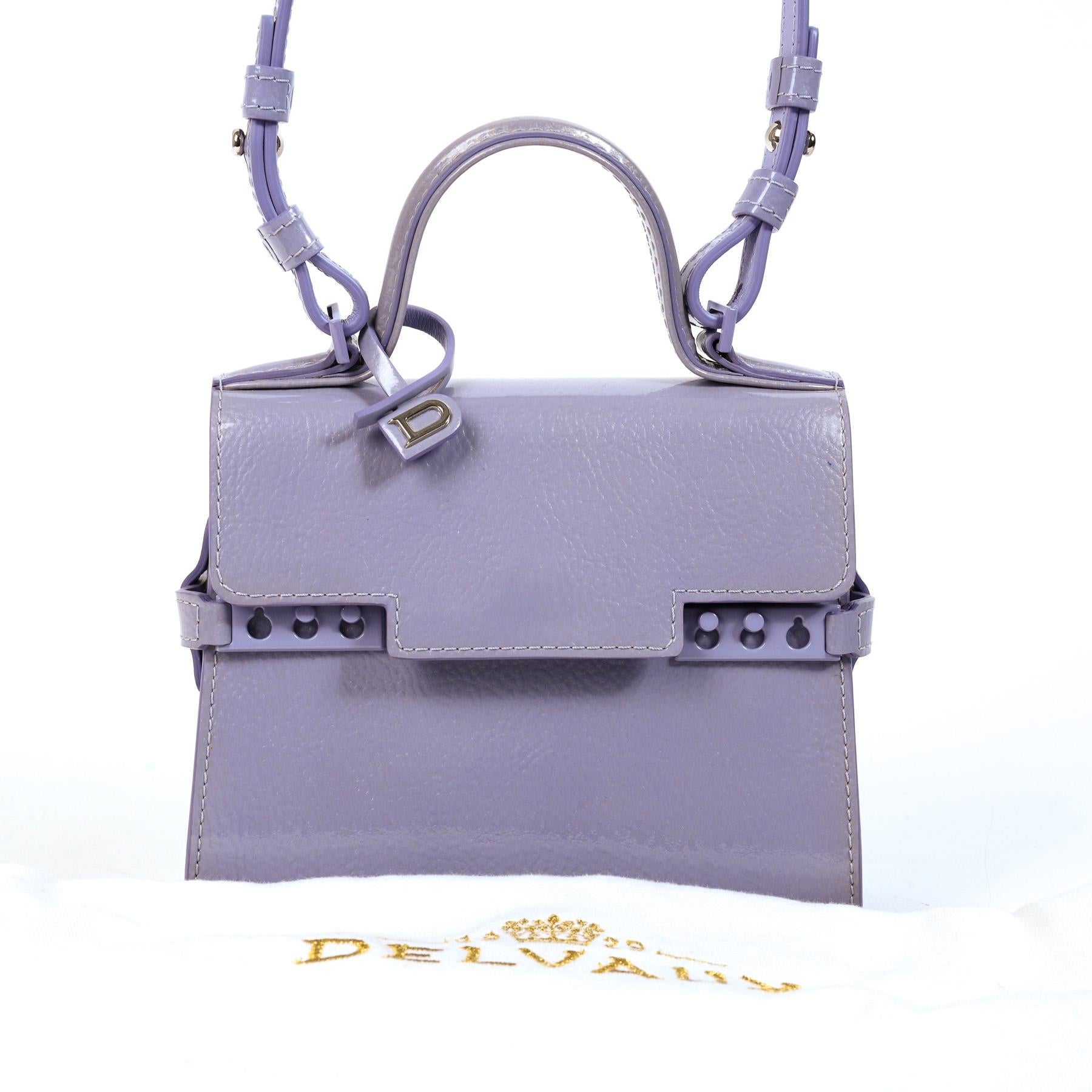 Delvaux Tempête Micro Lilac Vernis Gel

The most tiny member of the Delvaux Tempête family, the Delvaux Tempête Micro is now discontinued and highly sought after.

Made from Vernis Gel patent leather in Lilas purple, the bas has all the signature