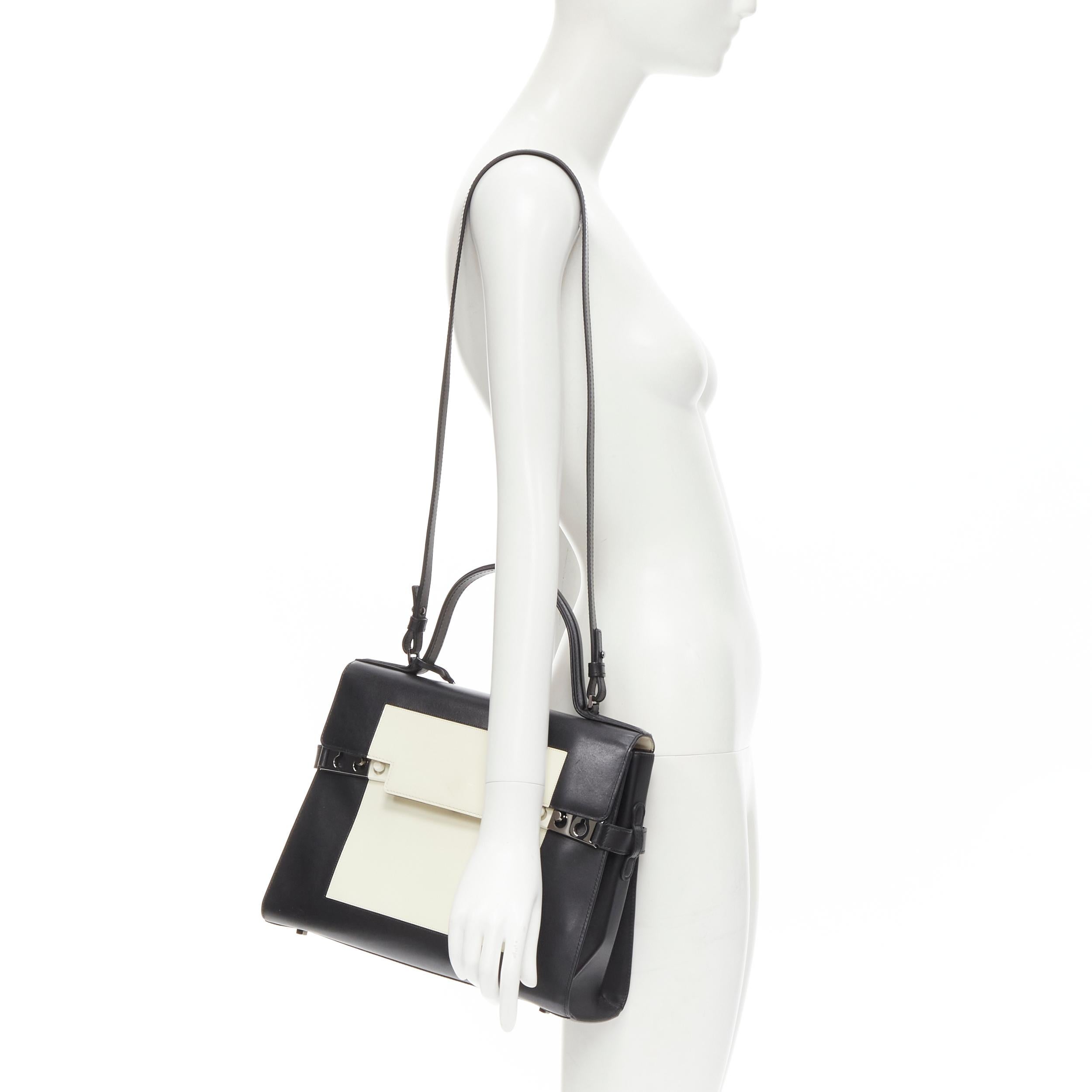 DELVAUX Tempete MM black leather white patent bicolor flap satchenl shoulder bag 
Reference: KEDG/A00112 
Brand: Delvaux 
Model: Tempete 
Material: Leather 
Color: Black 
Pattern: Solid 
Closure: Push lock 
Extra Detail: Black leather with white