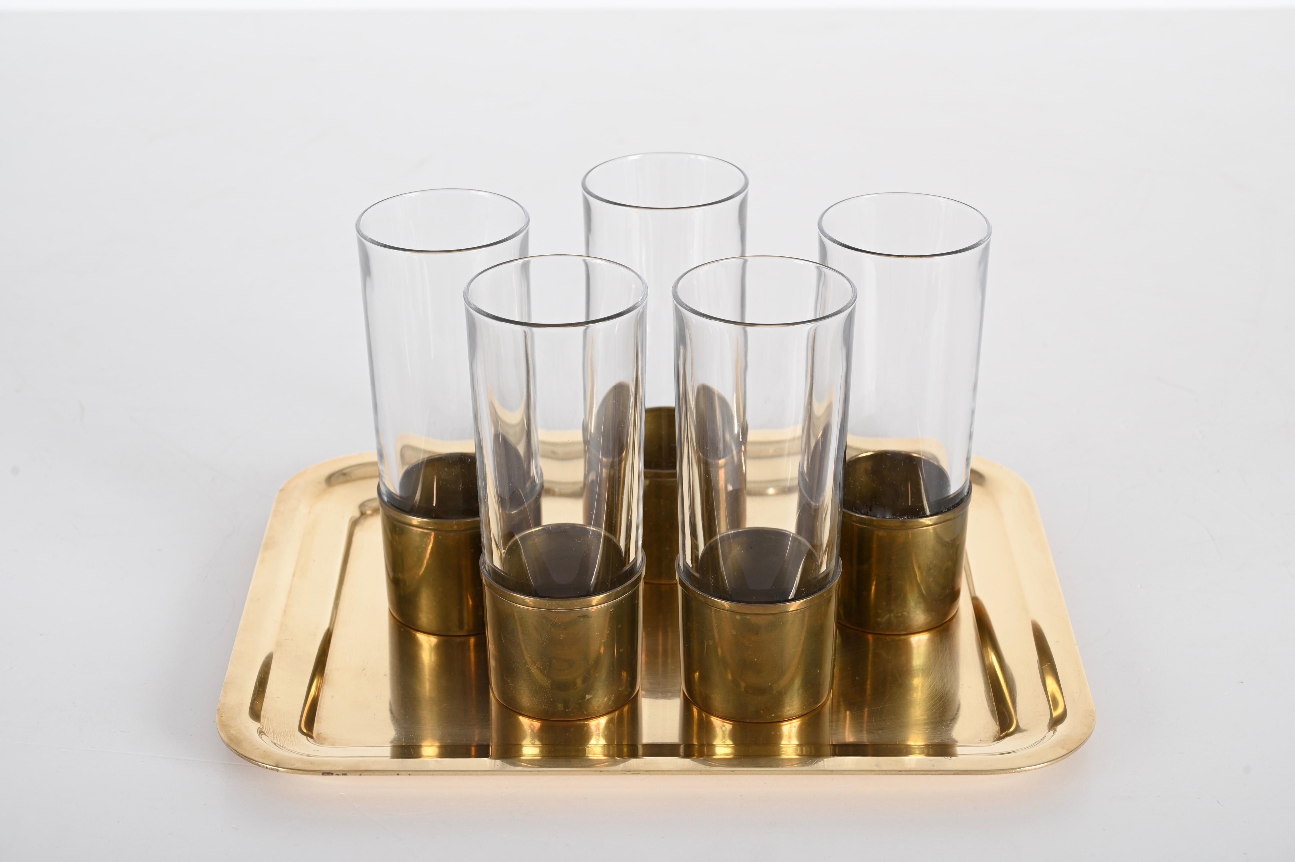 Excellent set of Italian crystal glasses with brass base ad tray. Claude Delvè designed this set in Italy during the 1970s for Delfi.

This piece is unique because it comprises five crystal glasses encased in a brass base. The glass can be used
