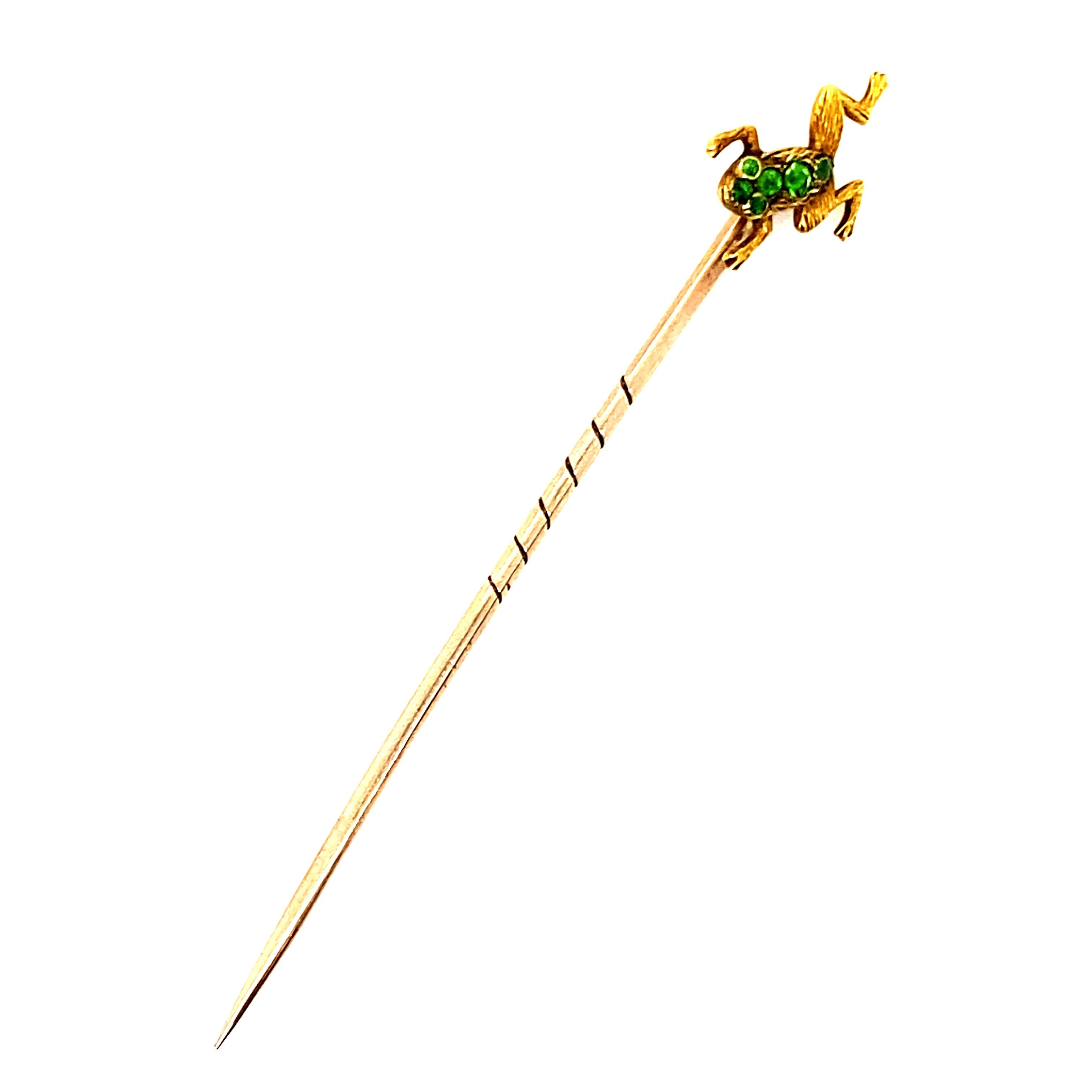 A demantoid garnet 15 karat yellow gold frog stick pin, circa 1950.

This charming stick pin depicts a realistically modelled frog which is beautifully hand detailed to show the frog's features, and is set to its head and tummy with round cut