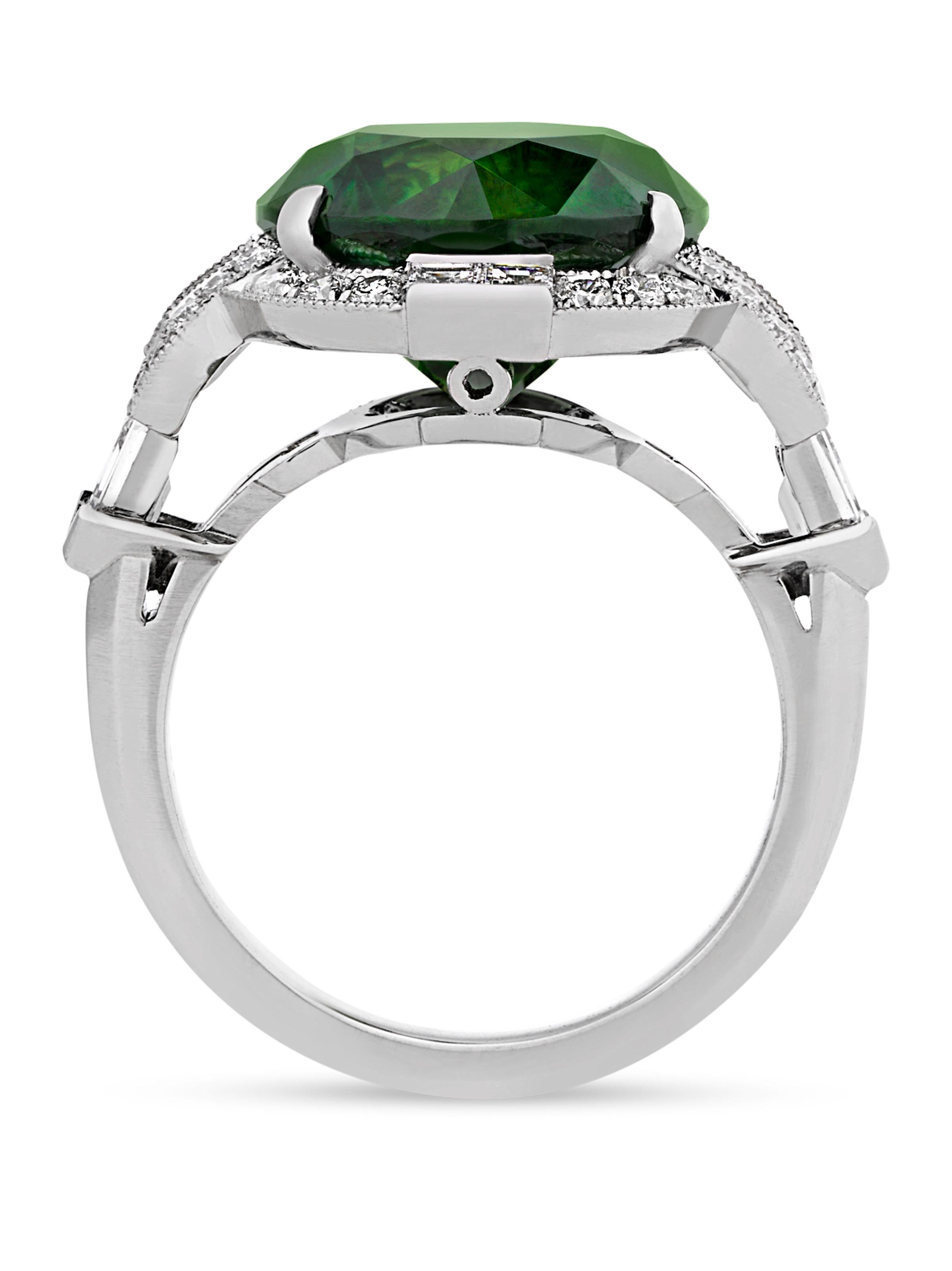 The demantoid garnet is among the rarest varieties of this coveted gemstone, and this example displays a particularly vivid, luminous green hue. Presented by famed jeweler Raymond Yard in an Art Deco-style platinum setting, the round brilliant-cut