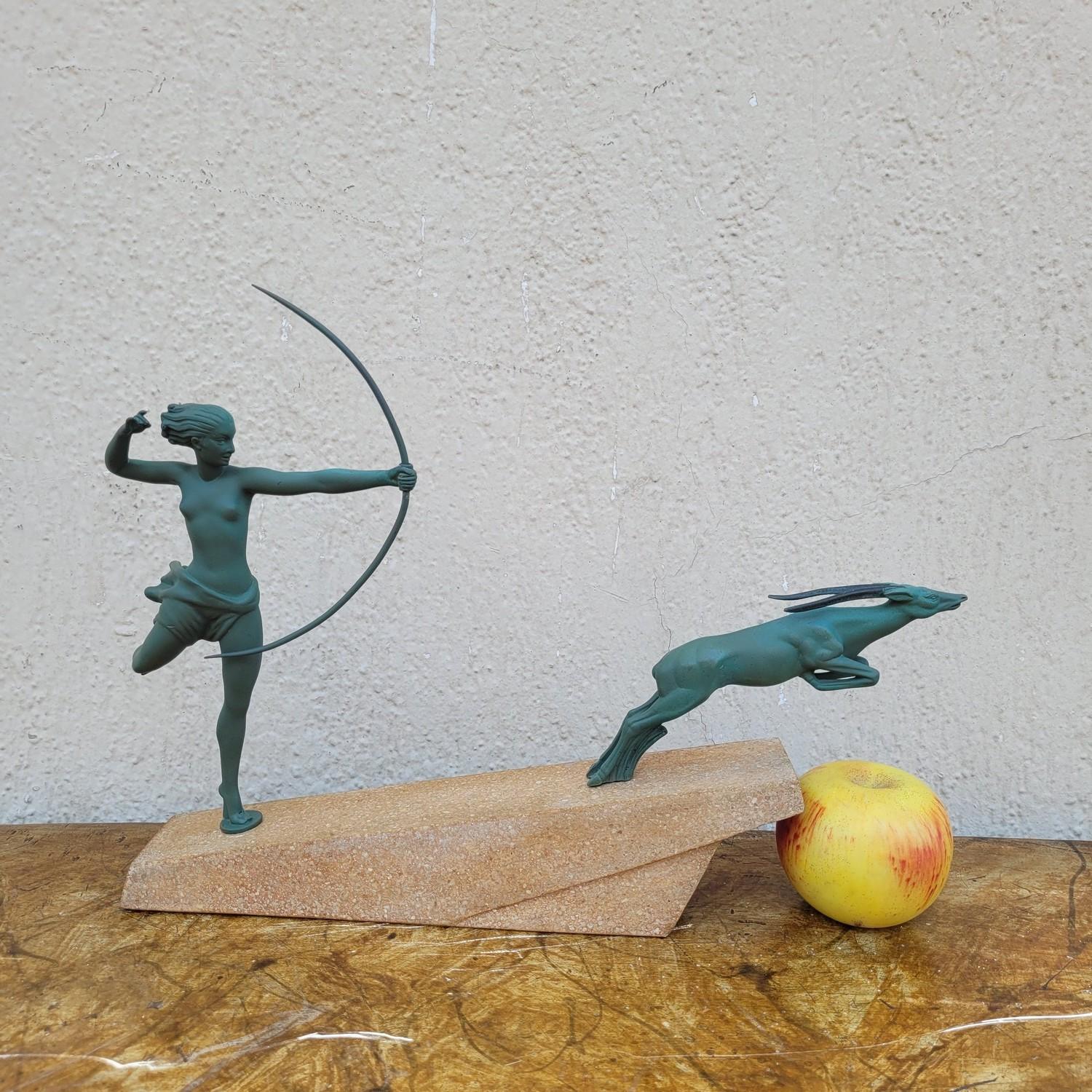 Spelter sculpture with green patina on a terrazzo base: Atalanta balancing on one foot, bends her bronze bow to hunt an antelope

Base signed Demarco; the character alone of Atalante was published by Max le Verrier

Art Deco

patina of time

Height
