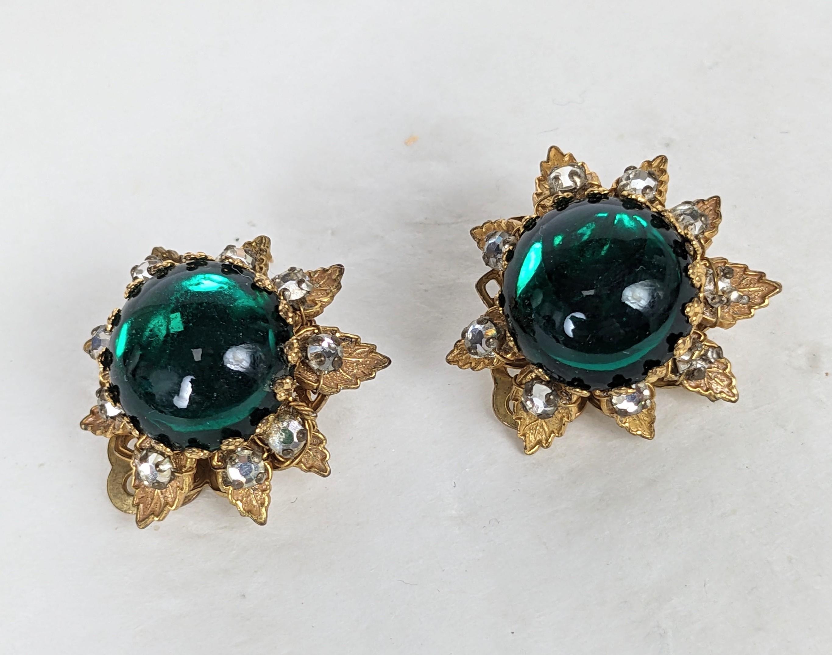Chaming DeMario Emerald Cabochon Flower Ear Clips from the 1950's. Emerald glass cab is surrounded by gilt leaves hand sewn with rose montee crystals. Clip back fittings. 1