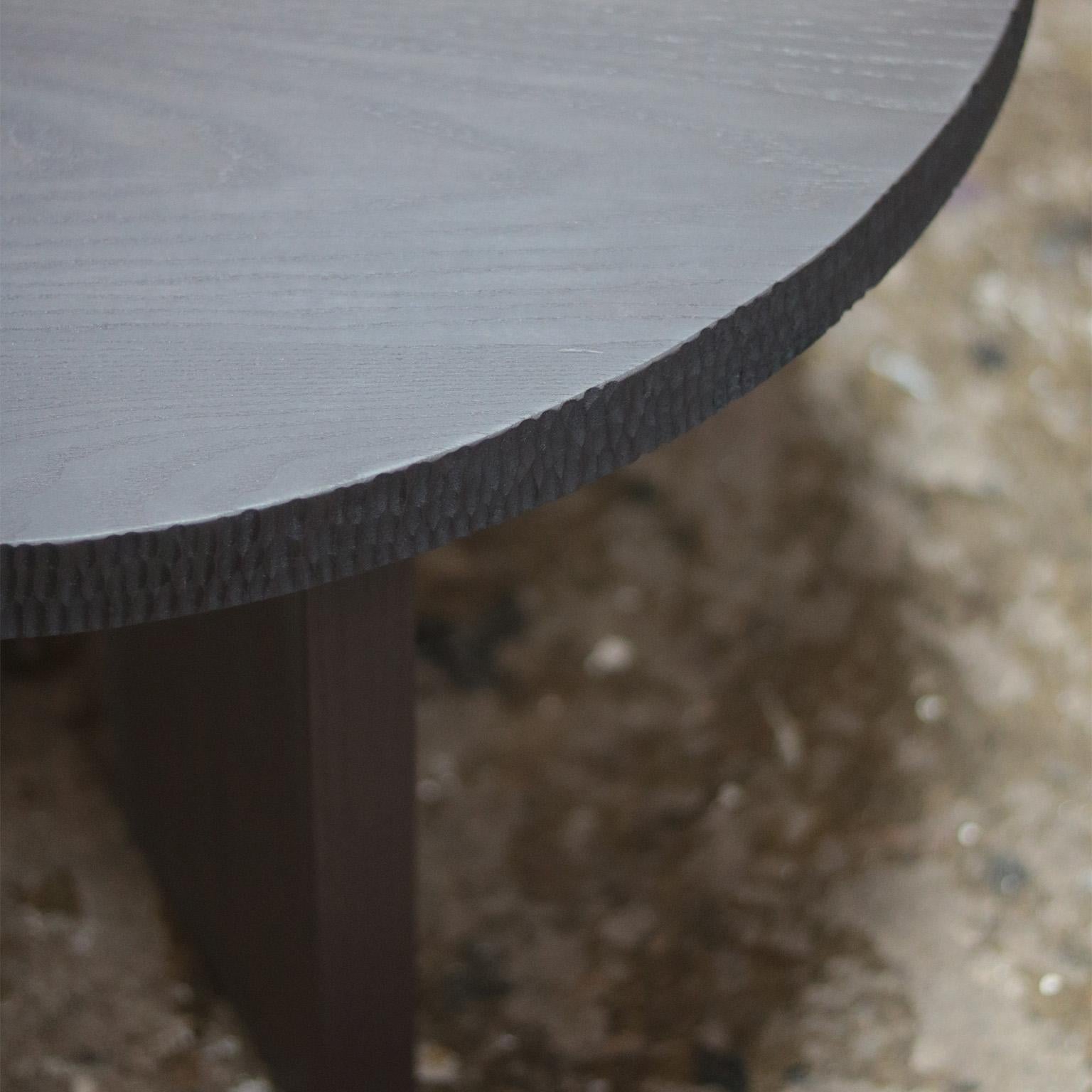 The Demeter table is constructed of solid ash wood.  The edge of the round top is lightly textured using traditional techniques to create an interesting, yet subtle deviation from the geometric silhouette.  Customers can request various wood options