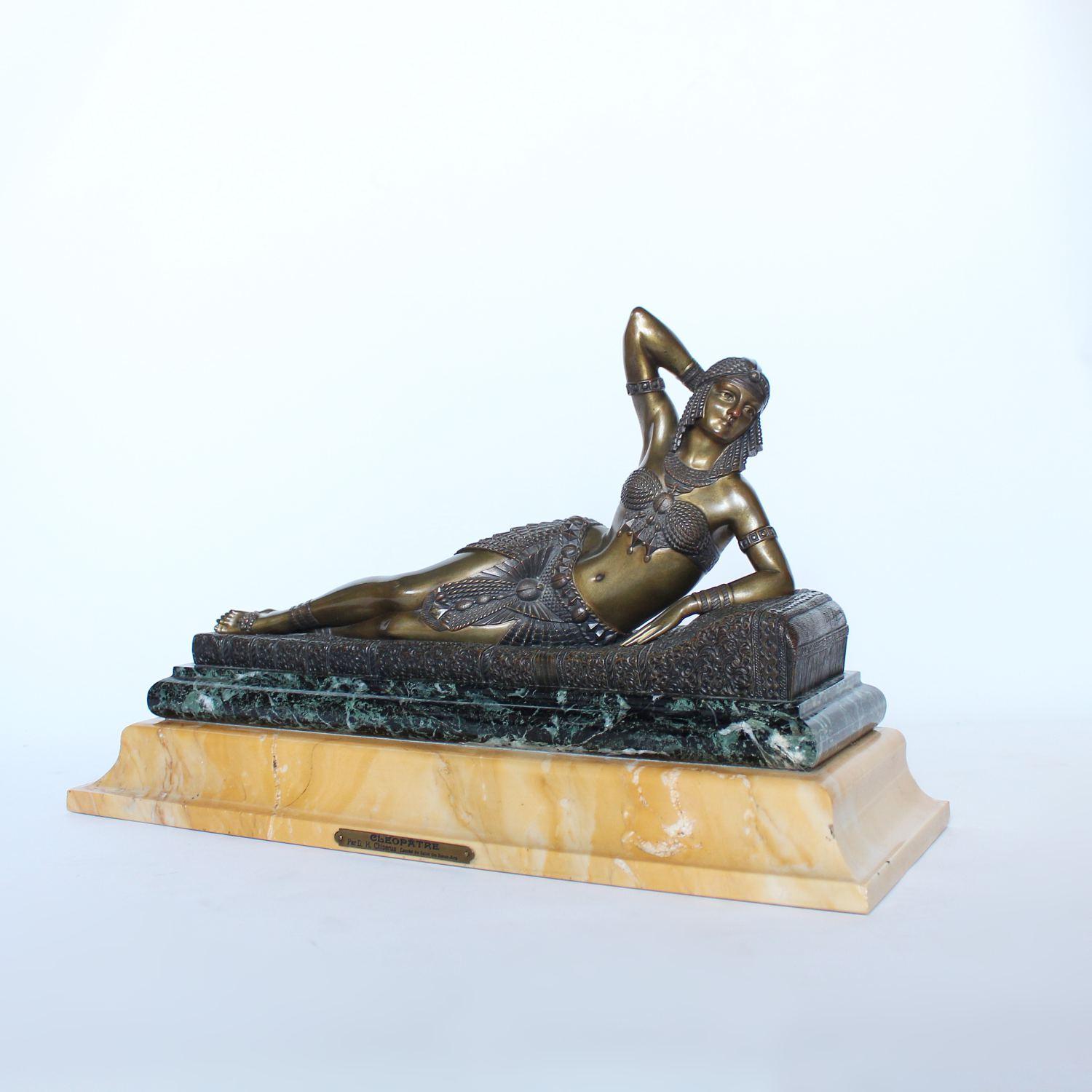 Cleopatra, an Art Deco, gilt and patinated bronze sculpture of Cleopatra, reclining on a daybed. Set over a bi-colored marble plinth.

Signed DH Chiparus to cast

Artist: Demetre Chiparus (1880-1947).

 