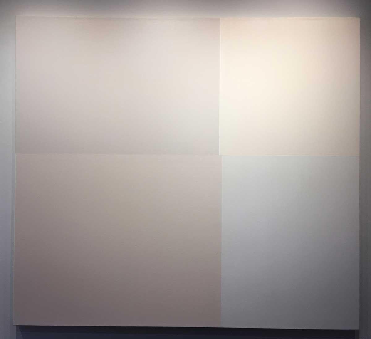This 54" x 60" painting by Canadian artist, Demetrios Papakostas presents a minimalist composition of subtle geometric forms rendered in muted, earthy, beige tones. The canvas is divided into distinct rectangular sections, with the dominant portion