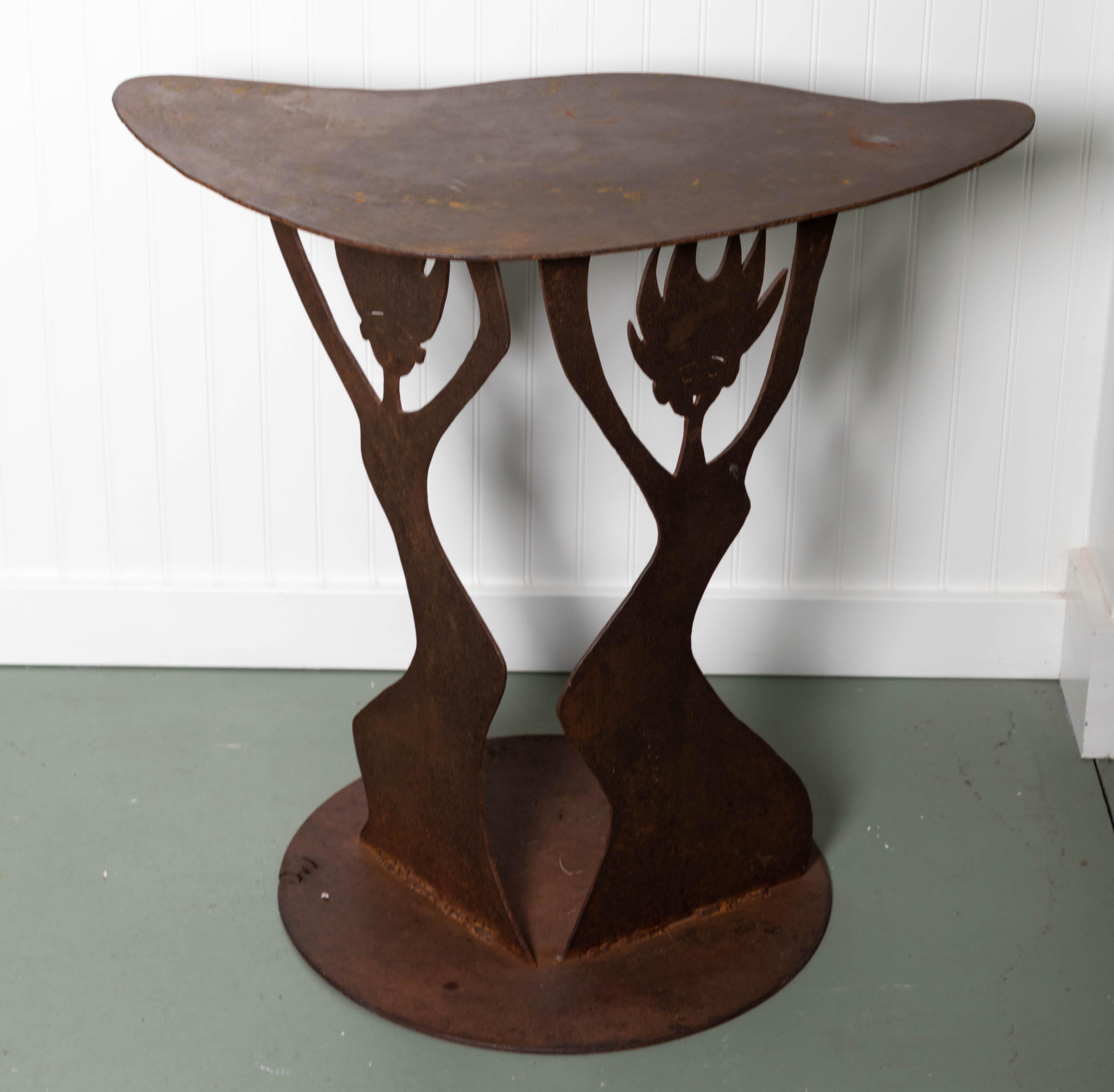 Demilune table handmade, signed MC with figural base. Surface treated to bring out rust color.